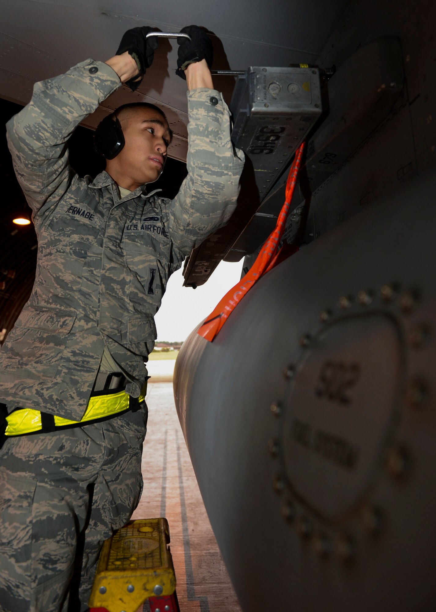 Senior Airman Daniel Bernabe, 493rd Aircraft Maintenance Unit load crew member, prepares an F-15C Eagle for munitions loading during the Load Crew of the Quarter competition at Royal Air Force Lakenheath, England, Jan. 12, 2015. The competition featured load crew teams from the 492nd, 493rd and 494th AMUs. (U.S. Air Force photo by Airman 1st Class Dawn M. Weber/Released)