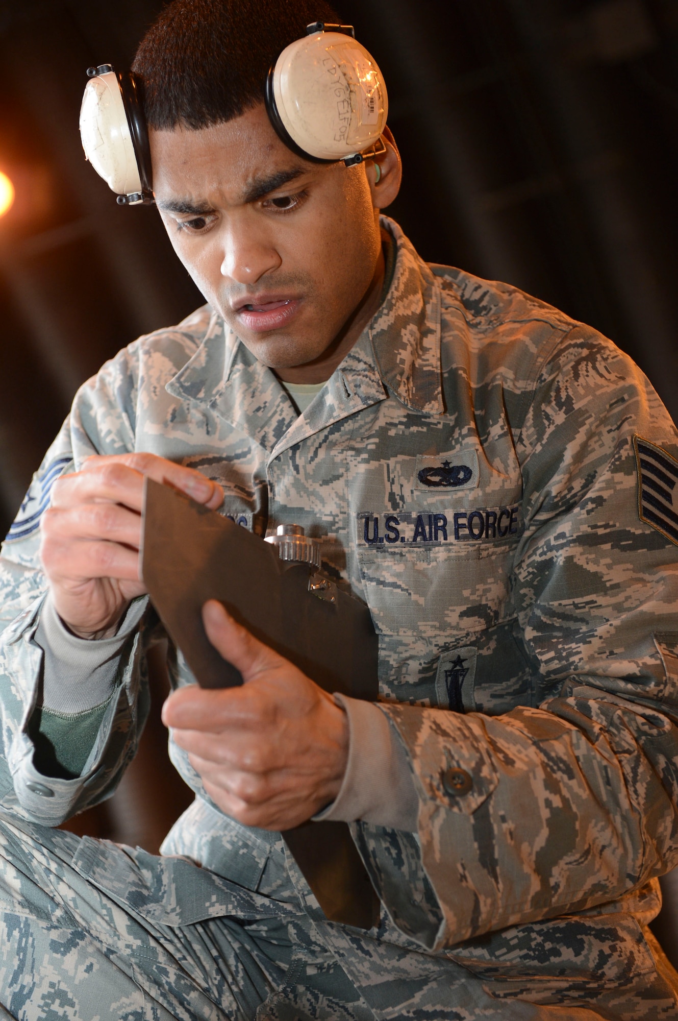 Tech. Sgt. Kelvin De Los Santos, 493rd Aircraft Maintenance Unit weapons crew chief, inspects an AIM-120 munition component during the Load Crew of the Quarter competition at Royal Air Force Lakenheath, England, Jan. 12, 2015. The competition featured load crew teams from the 492nd, 493rd and 494th AMUs. (U.S. Air Force photo by Airman 1st Class Dawn M. Weber/Released