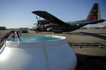 An inflatable tub is filled with water that will be pumped into a C-130 Hercules equipped with Modular Airborne Fire Fighting Systems (MAFFS), South Carolina Technology and Aviation Center, Greenville, S.C., April 27, 2010. MAFFS deploys a fire retardant mixed with fertilizer and red dye, but water is used for training purposes.