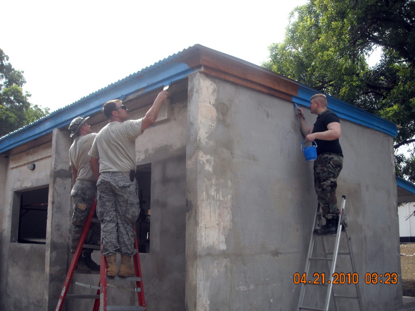 Airmen with the North Dakota National Guard's 119th Wing Civil Engineer Squadron paint the trim on a building on Burma Camp near Accra, Ghana. The building will serve as classrooms to train members of the Ghanaian Armed Forces. The two-week mission for the North Dakota Airmen is providing valuable training on contingency skills while helping Ghana — North Dakota's pair in the State Partnership Program.