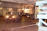 In this photo, 25th Infantry Division Soldiers drive their Humvees onto the USNS Sgt. Matej Kocak during load out operations  at Pearl Harbor.