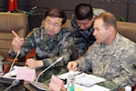 GUANGDONG PROVINCE, China (Jan. 12, 2015) - Maj. Gen. Edward Dorman is briefed by Qin Zeng at the Guangzhou Central Meteorological Observatory during China, U.S. military and civilian experts hold Disaster Management Exchange.   