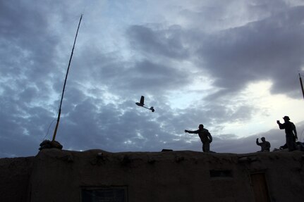 Cpl. Tomas Kleefisch, a military policeman assigned to Company B, 1-172nd Cavalry Squadron, 86th Infantry Brigade Combat Team of the Vermont National Guard, launches the RQ-11 Raven into the twilight skis of Afghanistan, April 14, 2010. Kleefisch is using the Raven is to gather video surveillance around the compound, where he and the rest of his platoon spent the night.