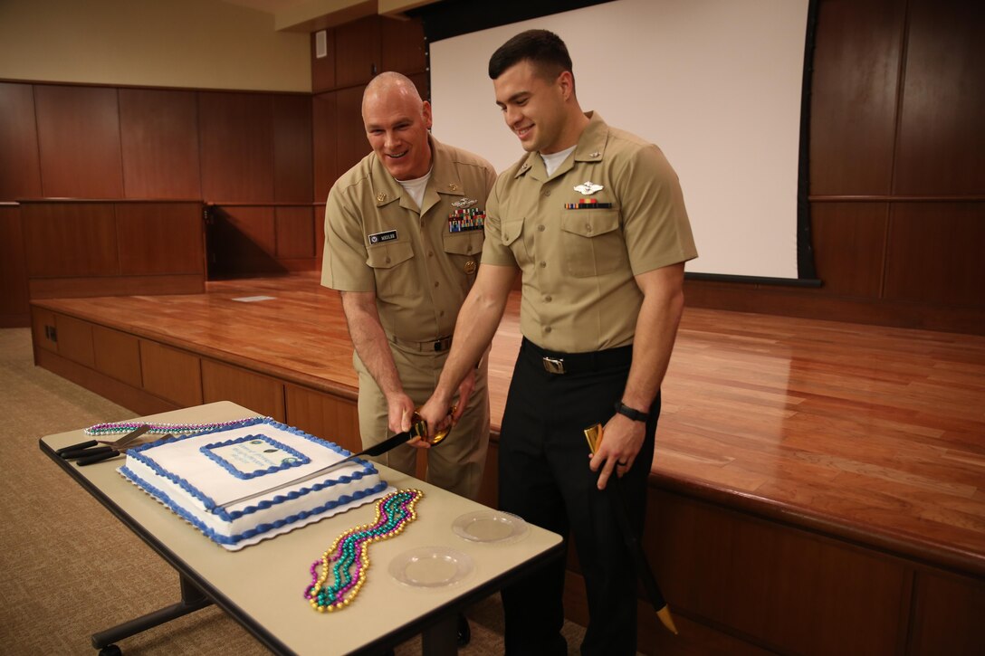 Master Chief Petty Officer Dino Medler (left), the 13th senior enlisted leader for the religious program specialist rating, cuts the Religion Program Specialist birthday cake with the youngest Sailor present, Religious Program Specialist 3rd Class OJ Barrera, on Jan. 14, 2014 at Marine Corps Support Facility New Orleans. Medler visited with Sailors at Marine Forces Reserve and Naval Air Station Joint Reserve Base New Orleans to celebrate the 36th anniversary of the creation of the religious program specialist rating, which was created Jan. 15, 1979. The religious program specialists at Marine Forces Reserve provide support to Navy chaplains in developing programs to meet the needs of Sailors and Marines throughout the Reserve Force. 