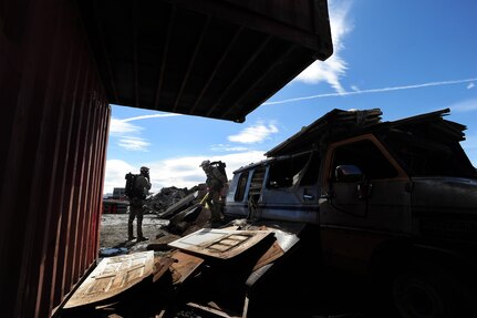 Members of the 212th Rescue Squadron make their way through rubble simulating a collapsed apartment building as part of the urban search and rescue portion of the training scenario of exercise Vigilant Guard in Anchorage, Alaska, Tuesday, April 27, 2010. Vigilant Guard is an annual, disaster-based training scenario that tests the coordination of National Guard units with local, state, regional, and national disaster preparedness organizations.