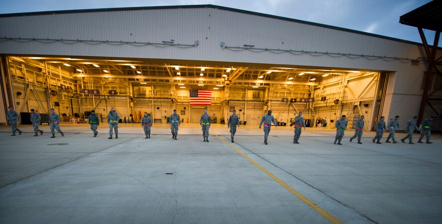 Airmen from the 901st Special Operations Maintenance Squadron line up prior to conducting a Foreign Object Damage prevention walk on the flightline at Hurlburt Field, Fla., Jan. 14, 2015. FOD walks decrease the chances of aircraft being damage by debris. (U.S. Air Force photo/Senior Airman Krystal M. Garrett)