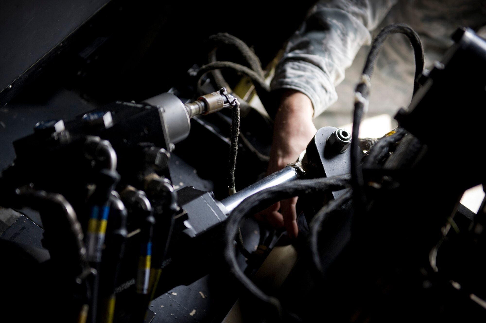 An Airman from the 1st Special Operations Aircraft Maintenance Squadron weapons load crew, tightens a 25mm Gatling gun on an AC-130U Gunship on the flightline at Hurlburt Field, Fla., Jan. 12, 2015. The Gatling gun is one of three weapons systems on the AC-130U. (U.S. Air Force photo/Senior Airman Krystal M. Garrett)