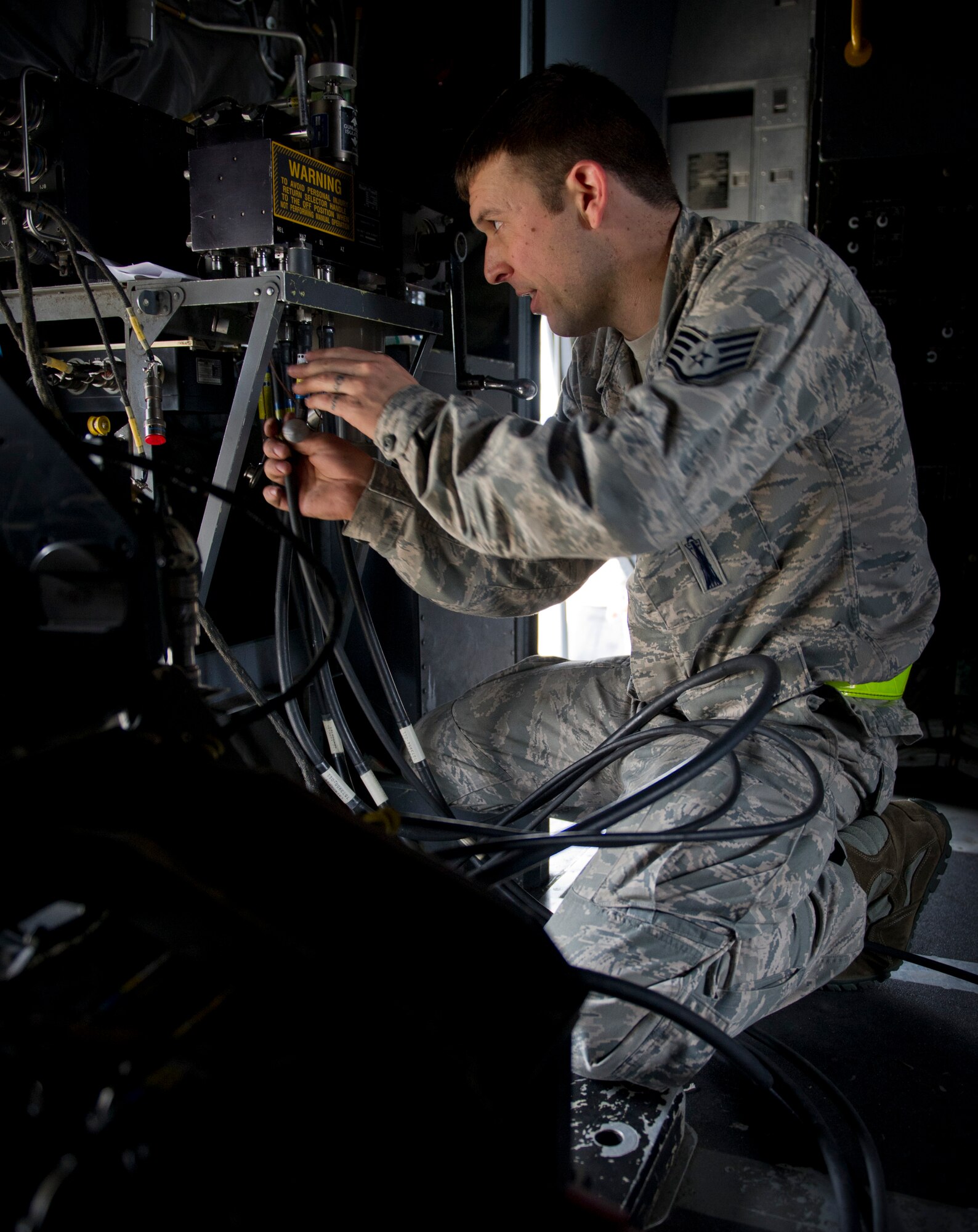 Staff Sgt. Charles Wolford, 1st Special Operations Aircraft Maintenance Squadron weapons load team chief, connects a 25mm Gatling gun control unit in an AC-130U Gunship on the flightline at Hurlburt Field, Fla., Jan. 12, 2015. The Gatling gun is one of three weapons systems on the AC-130U. (U.S. Air Force photo/Senior Airman Krystal M. Garrett)