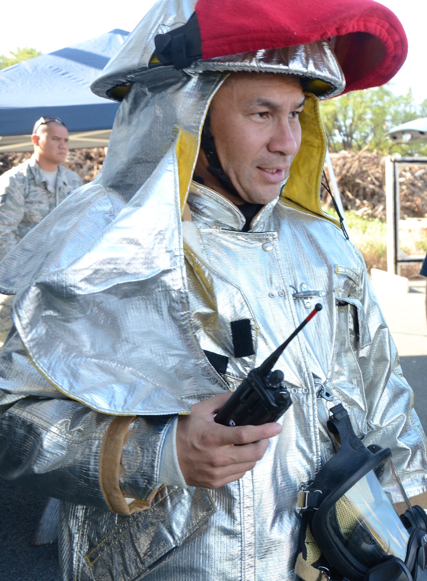 Tech. Sgt. Brandon Apuna, a firefighter with the 624th Civil Engineering Squadron, mans a portable radio during a live-fire training exercise at Hickam Field, Hawai’i, Jan. 10, 2015. Firefighters use radios  to execute command and control, to communicate observations and progress, and to receive updated orders. (U.S. Air Force photo by Tech. Sgt. Phyllis Keith)