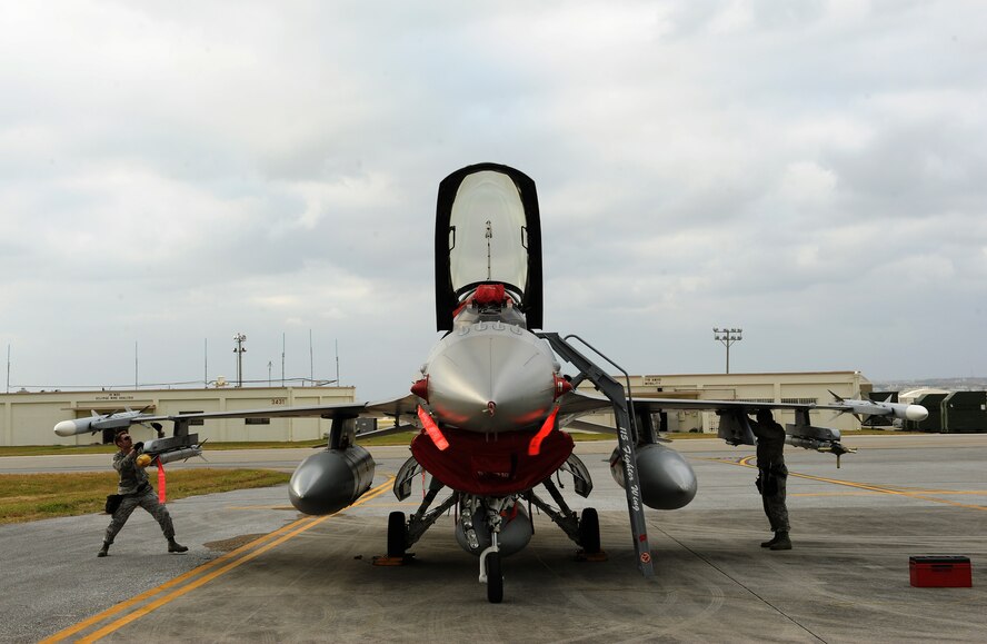 Members from the Wisconsin Air National Guard 115th Fighter Wing, Truax Field Air National Guard Base, Wisconsin, secure an F-16 Fighting Falcon on the flightline of Kadena Air Base, Japan, Jan. 15, 2015. The guardsmen deployed to Kadena in support of a theater security package. These deployments underscore U.S. commitment to the Asia-Pacific rebalance and bolster U.S. military capabilities in the region. (U.S. Air Force photo by Airman 1st Class Zade C. Vadnais)