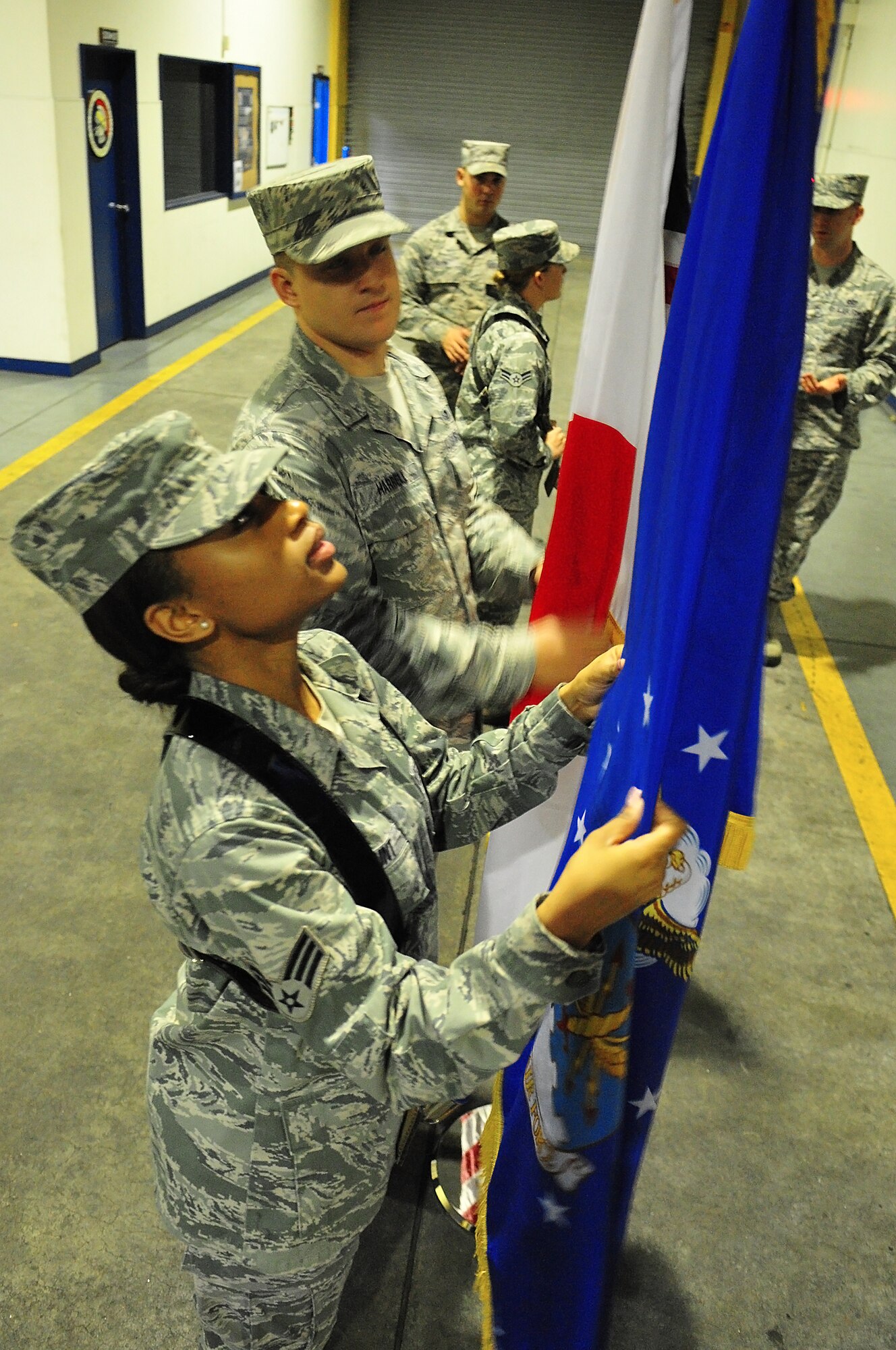 U.S. Air Force Senior Airman Abigail Blount, 35th Medical Support Squadron medical logistics technician, practices adjusting the spade of the flagstaff during a Base Honor Guard practice at Misawa Air Base, Japan, Jan. 14, 2015. Flag carriers have a span of approximately nine seconds to adjust the spade to ensure the flag’s folds are tight and even. (U.S. Air Force photo by Senior Airman Jose L. Hernandez-Domitilo/Released) 