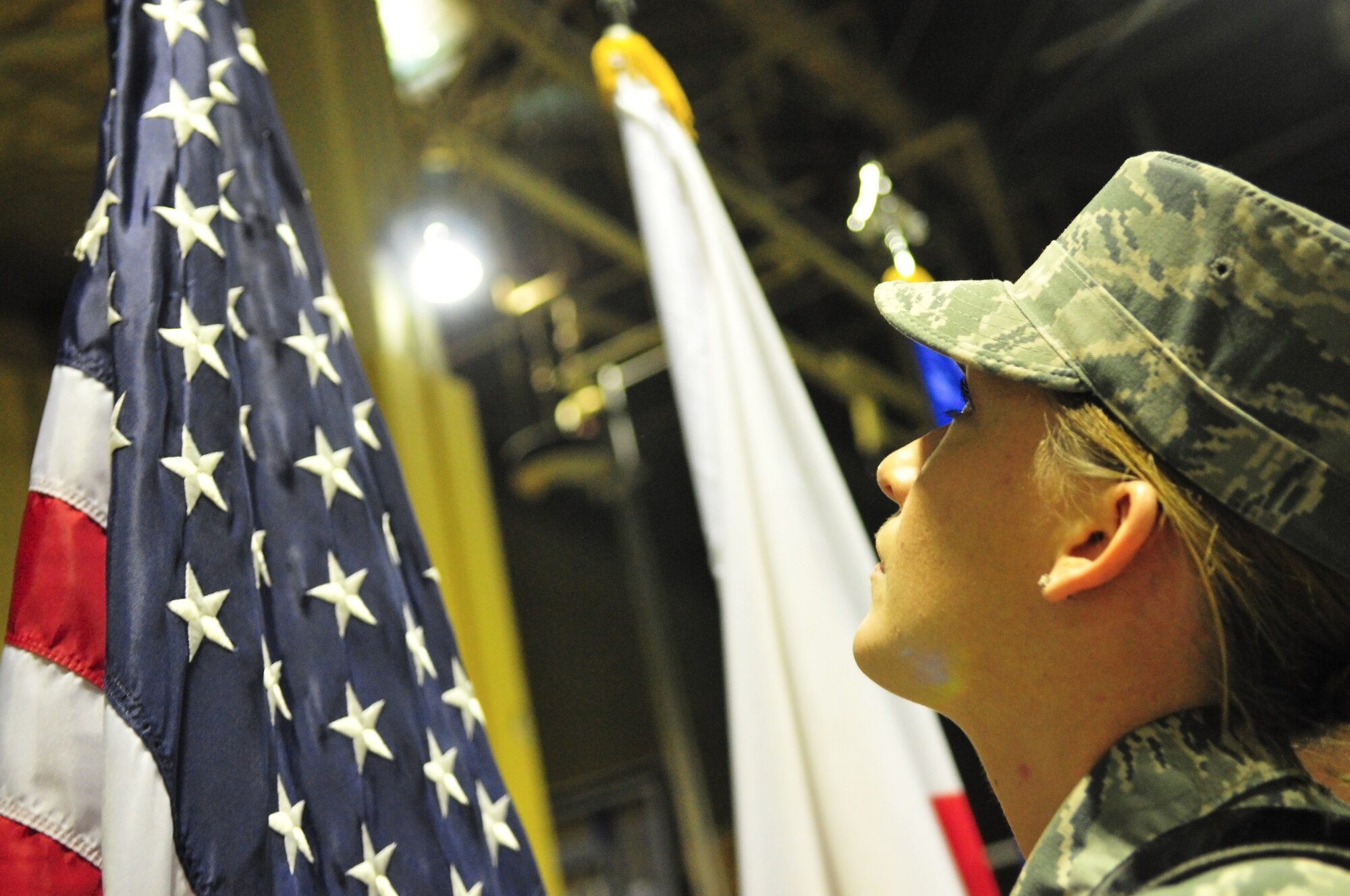 U.S. Air Force Airman 1st Class Kristen R. Marcum, 35th Civil Engineer Squadron operations management journeyman, adjusts the spade of the flagstaff during Base Honor Guard practice at Misawa Air Base, Japan, Jan. 14, 2015. After forming a diamond shape near the center of the flag, Marcum must tilt her head up at a three-second cadence to adjust the view and spade. (U.S. Air Force photo by Senior Airman Jose L. Hernandez-Domitilo/Released)