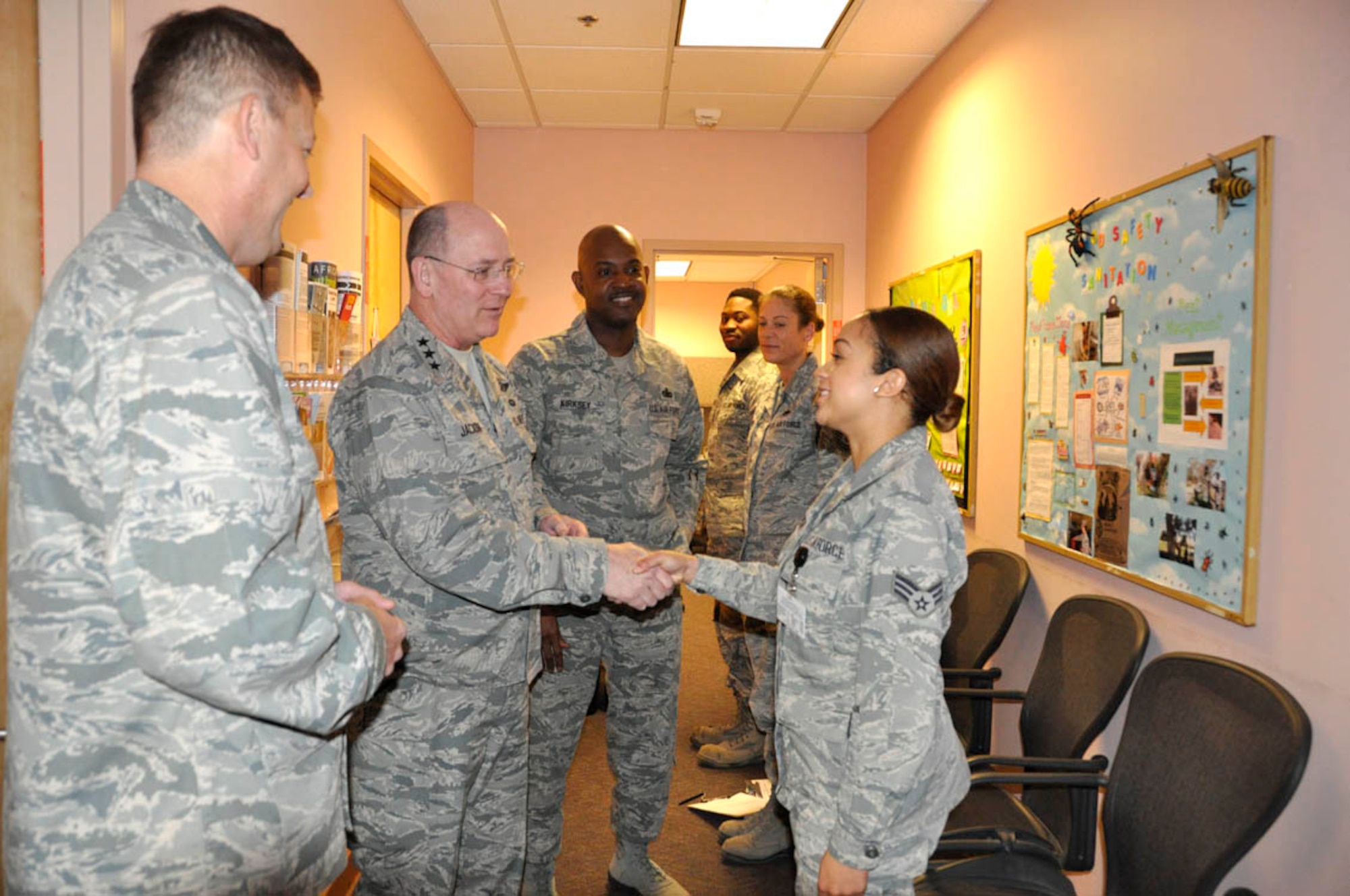 (Left) Lt. Gen. James Jackson, Chief of Air Force Reserve and Commander, Air Force Reserve Command, recognizes and thanks Senior Airman Chelsie Harrison for her superior performance in the 926th Aerospace Medical Squadron at the flight medicine facility Jan. 11. (U.S. Air Force photo/Maj. Jessica Martin)