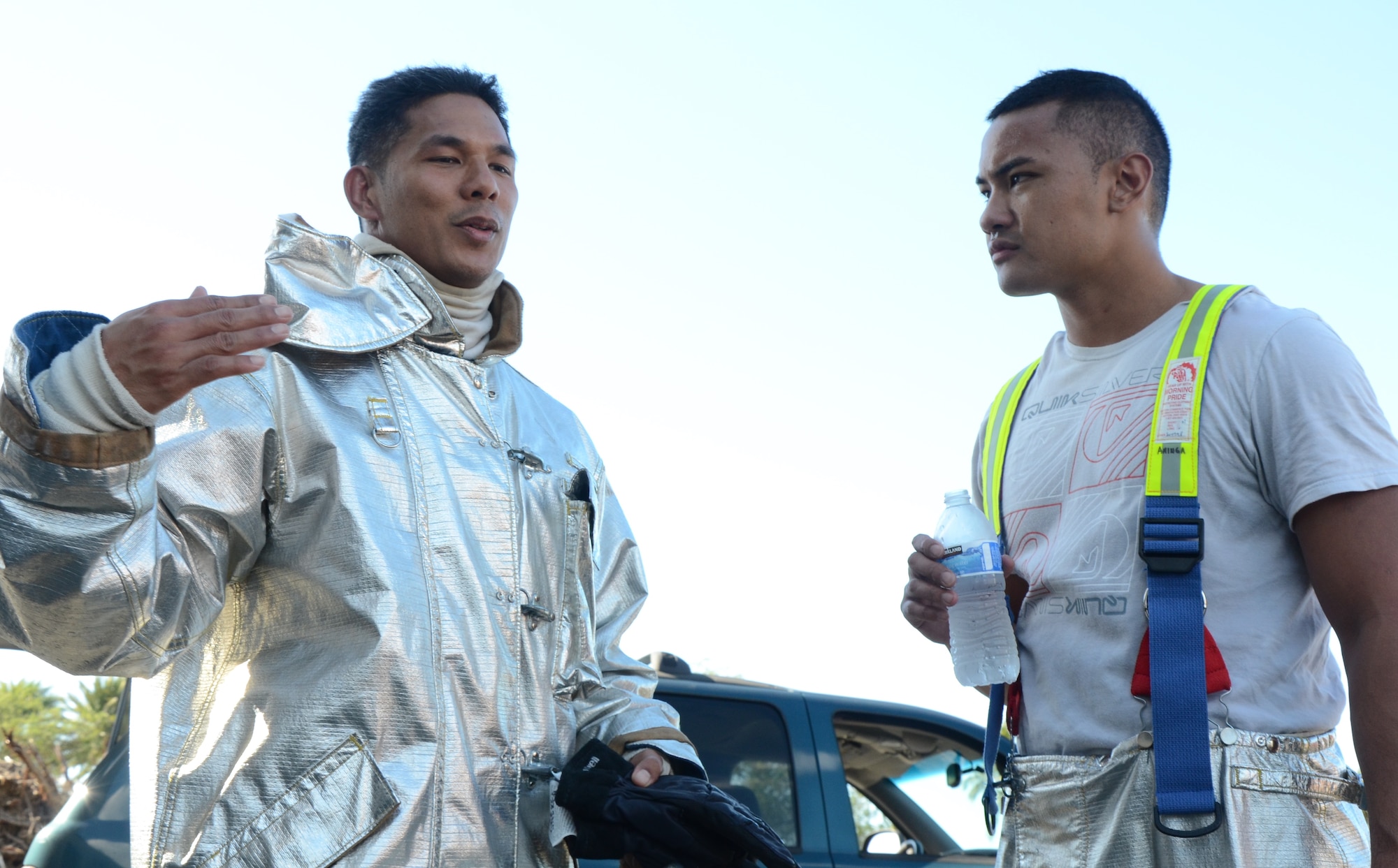 Staff Sgt. Jonathan "Kaipo" Onekea, left, and Senior Airman Pomai Ahinga, right, firefighters with the 624th Civil Engineering Squadron, informally debrief each other after teaming up in a live-fire burn exercise, Hickam Field, Hawai'i, Jan. 10, 2015. Due to the tactical details and high risk involved, firefighters must be ready to identify their own mistakes and be willing to constructively talk about others’ mistakes. (U.S. Air Force photo by Tech. Sgt. Phyllis Keith)