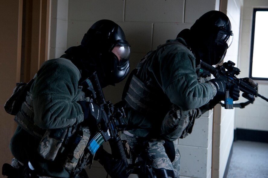 Members of the 51st Security Forces Squadron search a building during an active-shooter exercise Jan. 14, 2015, at Osan Air Base, Republic of Korea. The exercise was part of a multi-day combat readiness course that trains and tests SFS Airmen on their abilities to execute emergency operations. (U.S. Air Force photo by Senior Airman Matthew Lancaster)
