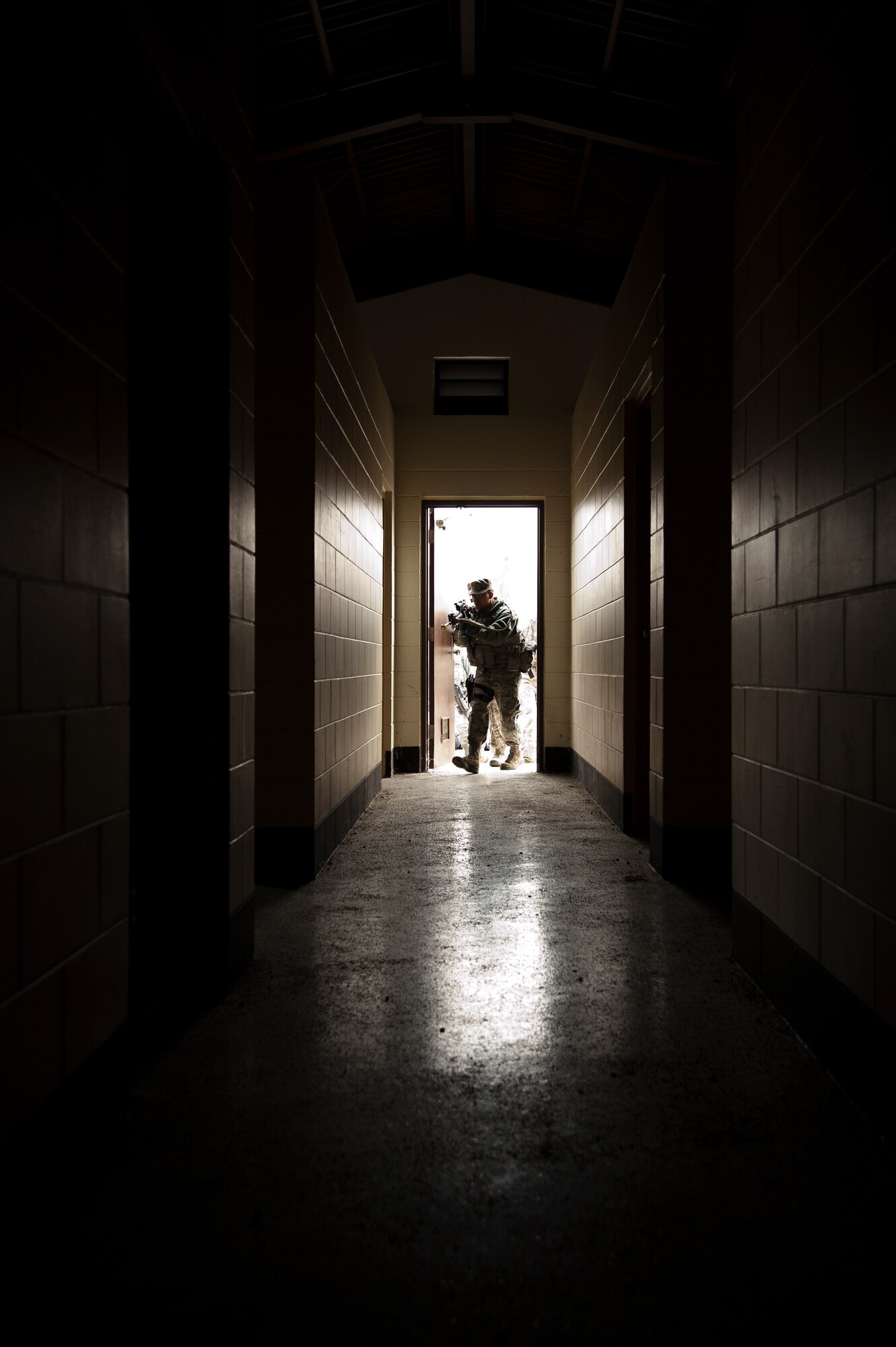 A member of the 51st Security Forces Squadron searches a building during an active-shooter exercise Jan. 14, 2015, at Osan Air Base, Republic of Korea. The exercise was part of the Combat Readiness Course, which is a multi-day course designed to test their readiness and skills in defending the base. (U.S. Air Force photo by Senior Airman Matthew Lancaster)