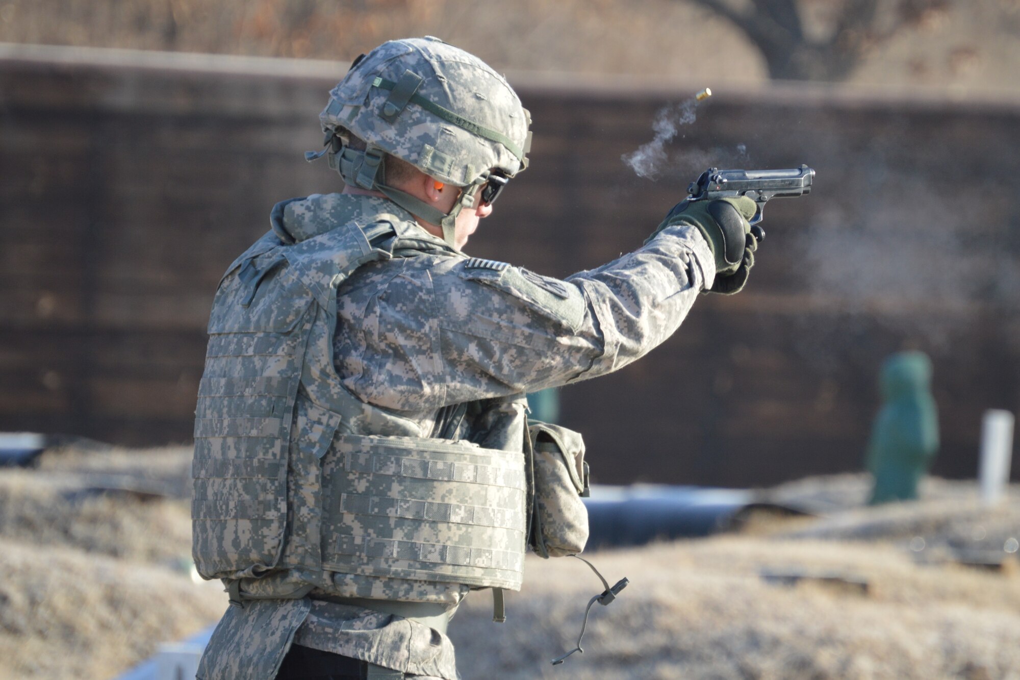 Army Lt. Col. Ethan Hall, commander of 6th Battalion, 52nd Air Defense Artillery Regiment, fires an M9 pistol at the qualification range at Warrior Base during the Iron Warrior exercise, Jan 5 – 12, 2015.  The training exercise honed the air defenders’ combat skills and marksmanship proficiencies as well as air and missile defense training.  (U.S. Army photo by Cpl. Shin, YoungJae)
