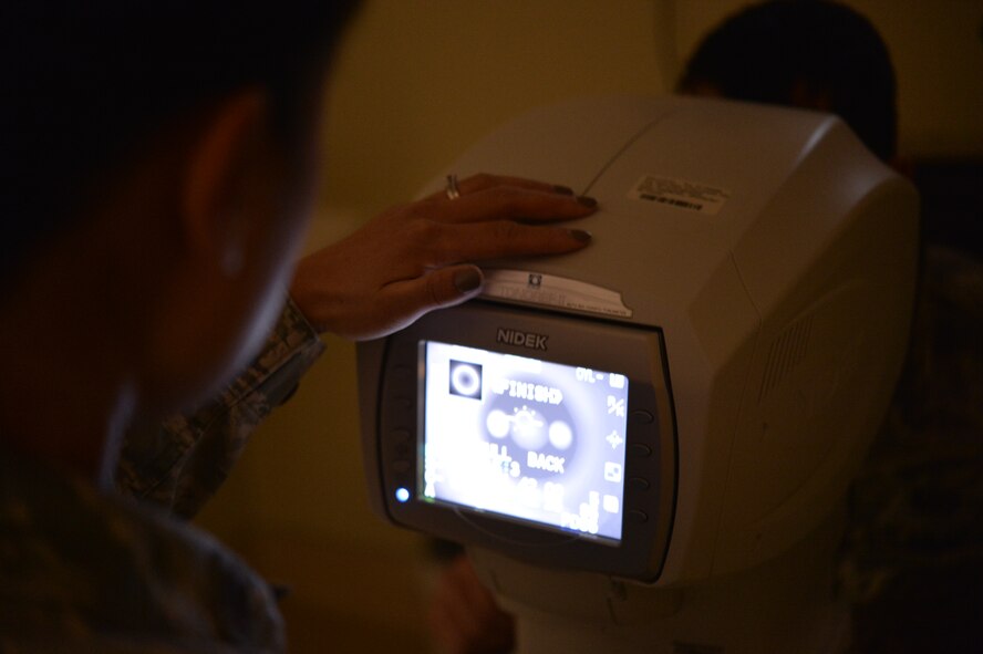 Maj. Ivy Madson, 99th Air Base Squadron optometry flight commander, uses a non-contact Tonometer to measure the eye pressure for Airman 1st Class Hunter, 18th Reconnaissance Squadron Airman, Jan. 13, 2015, during an eye exam at Creech Air Force Base, Nevada. The Creech Medical Aid station now offers optometry services such as routine eye examinations, acute visits, limited contact lens prescriptions renewals and follow-up exams. (Last names have been withheld for security purposes). (U.S. Air Force photo by Staff Sgt. Adawn Kelsey/Released)