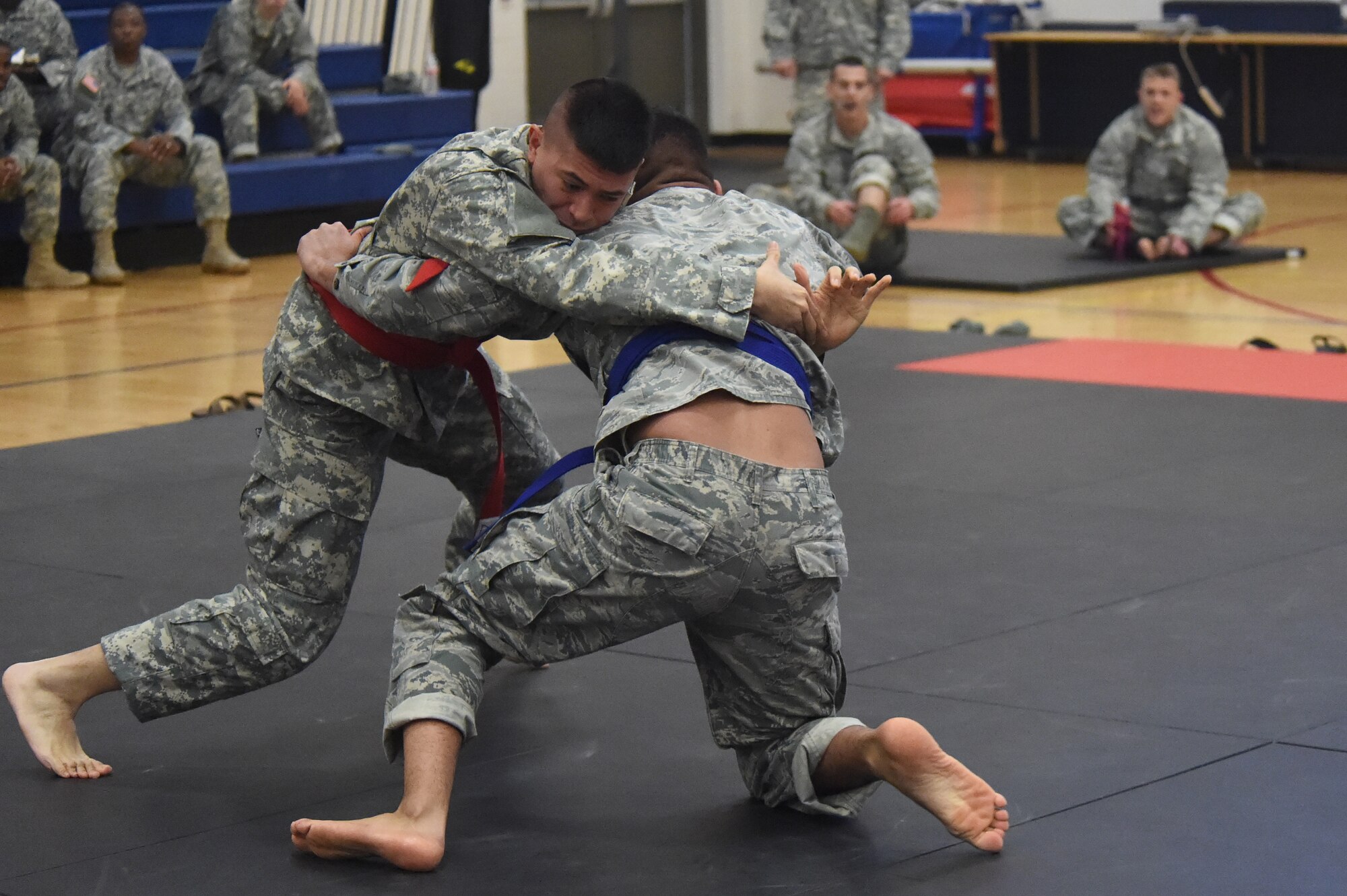 Two U.S. Army 743rd Military Intelligence Battalion Squadron members compete for commander’s cup points during a combatives tournament at the Buckley Fitness Center Jan. 15, 2015, on Buckley Air Force Base, Colo. The army battalion hosts the tournament every year to hone hand-to-hand combat training techniques while engaging in friendly competition. (U.S. Air Force photo by Airman 1st Class Samantha Saulsbury/Released)