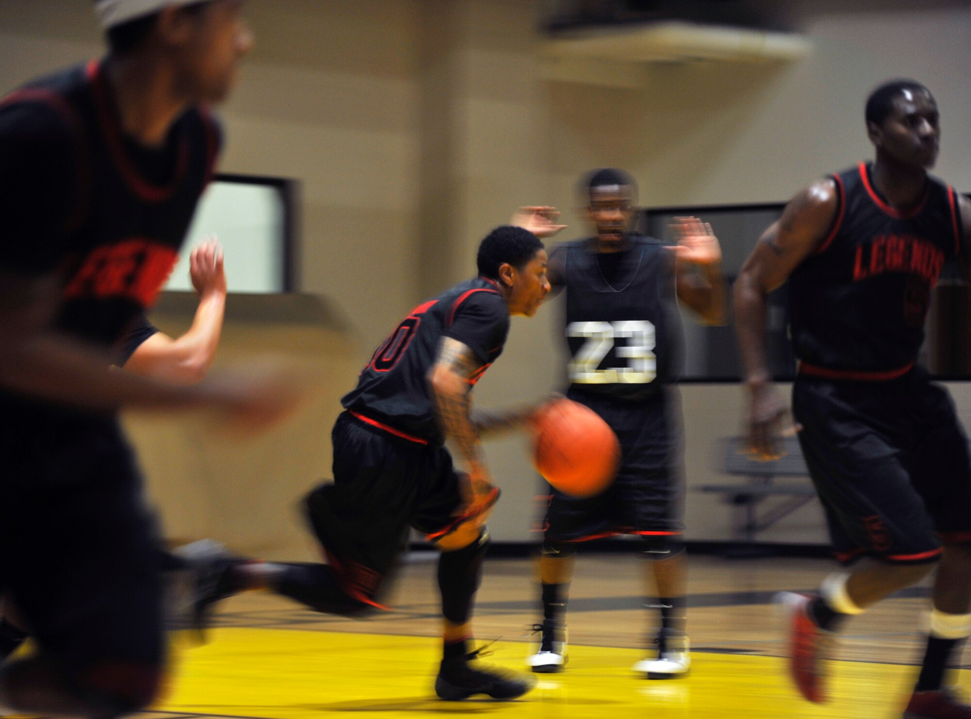 A member of the 19th Maintenance Group pushes the ball down the court during a fast break Jan. 12, 2015, at Little Rock Air Force Base, Ark. The 19th Maintenance Group played against the 19th Force Support Squadron during the opening game of the season. (U.S. Air Force photo by Senior Airman Stephanie Serrano)