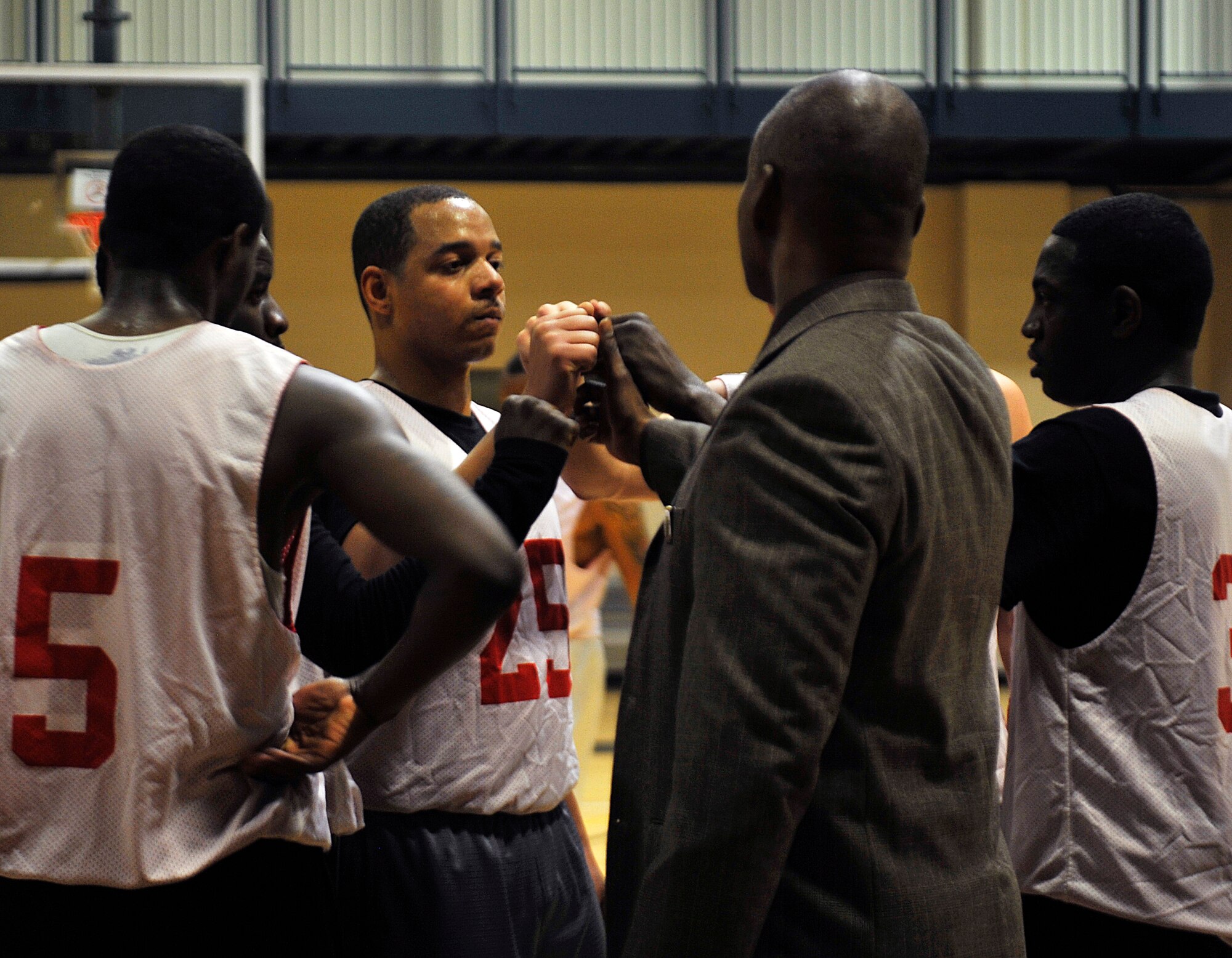 The 19th Force Support Squadron intramural basketball team collaborates during halftime Jan. 12, 2015, at Little Rock Air Force Base, Ark. Each Monday, Tuesday, Wednesday and Thursday, games are played at 5:30, 6:30 and 7:30 p.m. (U.S. Air Force photo by Senior Airman Stephanie Serrano)