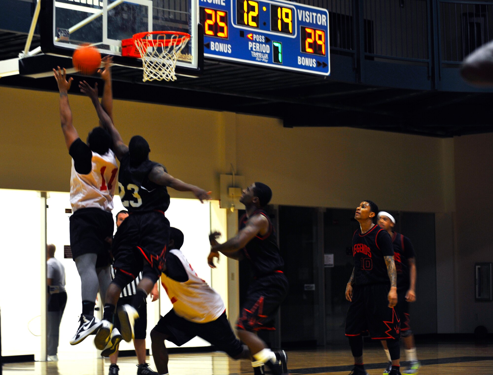 A player from the 19th Force Support Squadron and a player of the 19th Maintenance Group jump for a rebound Jan. 12, 2015, during an intramural basketball game at Little Rock Air Force Base, Ark. The 19th MXG defeated the 19th FSS 55-46. (U.S. Air Force photo by Senior Airman Stephanie Serrano)
