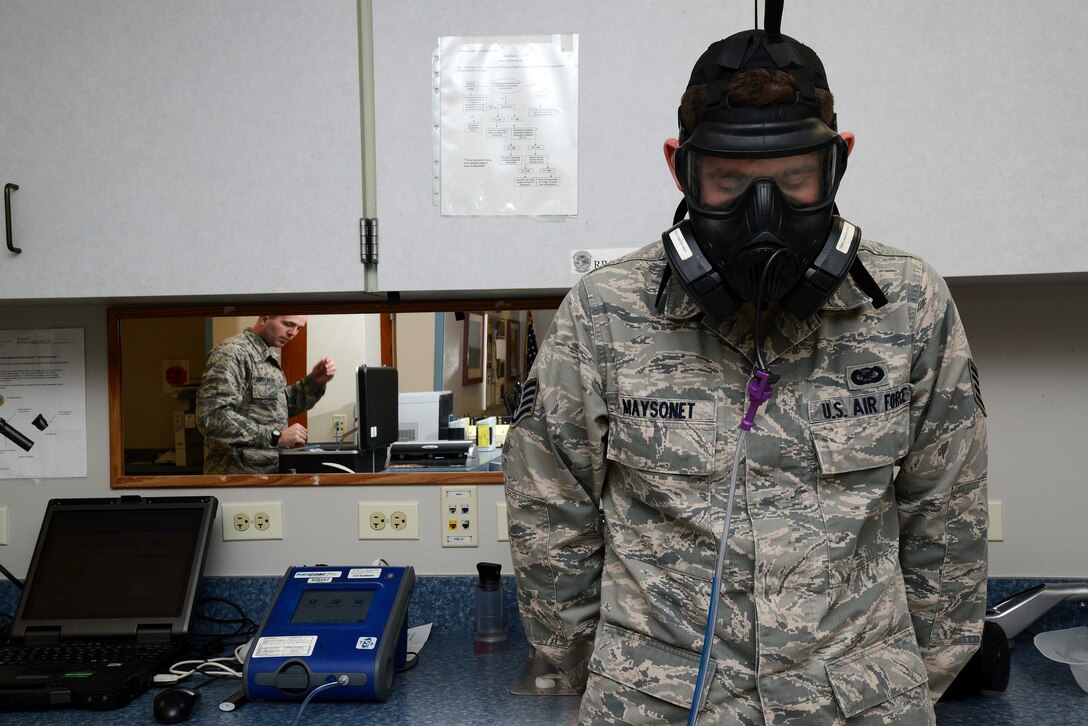 Staff Sgt. Nathan Maysonet, 47th Flying Training Wing public affairs photojournalist, completes his fit test for the M50 chemical protective mask at the 47th Medical Operations Squadron Bioenvironmental Engineering office on Laughlin Air Force Base, Texas, Jan. 12, 2015. The fit test requires the user to don their own mask and perform a series of exercises that simulate typical activities to ensure the mask fits properly and provides a good seal. (U.S. Air Force photo by Airman 1st Class Ariel D. Delgado)(Released)