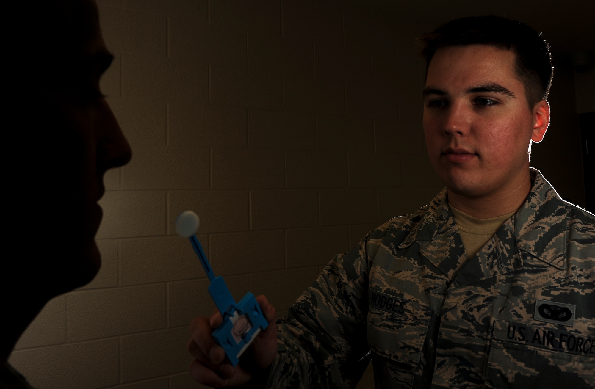 Staff Sgt. Thomas Hodges, the 19th Security Forces Squadron noncommissioned officer-in-charge of confinement, demonstrates performing a DNA swab Jan. 13, 2015, at Little Rock Air Force Base, Ark. Hodges obtains DNA samples while in-processing inmates, and then sends each to the U.S. Army criminal investigation lab in Georgia. (U.S. Air Force photo by Airman 1st Class Scott Poe)