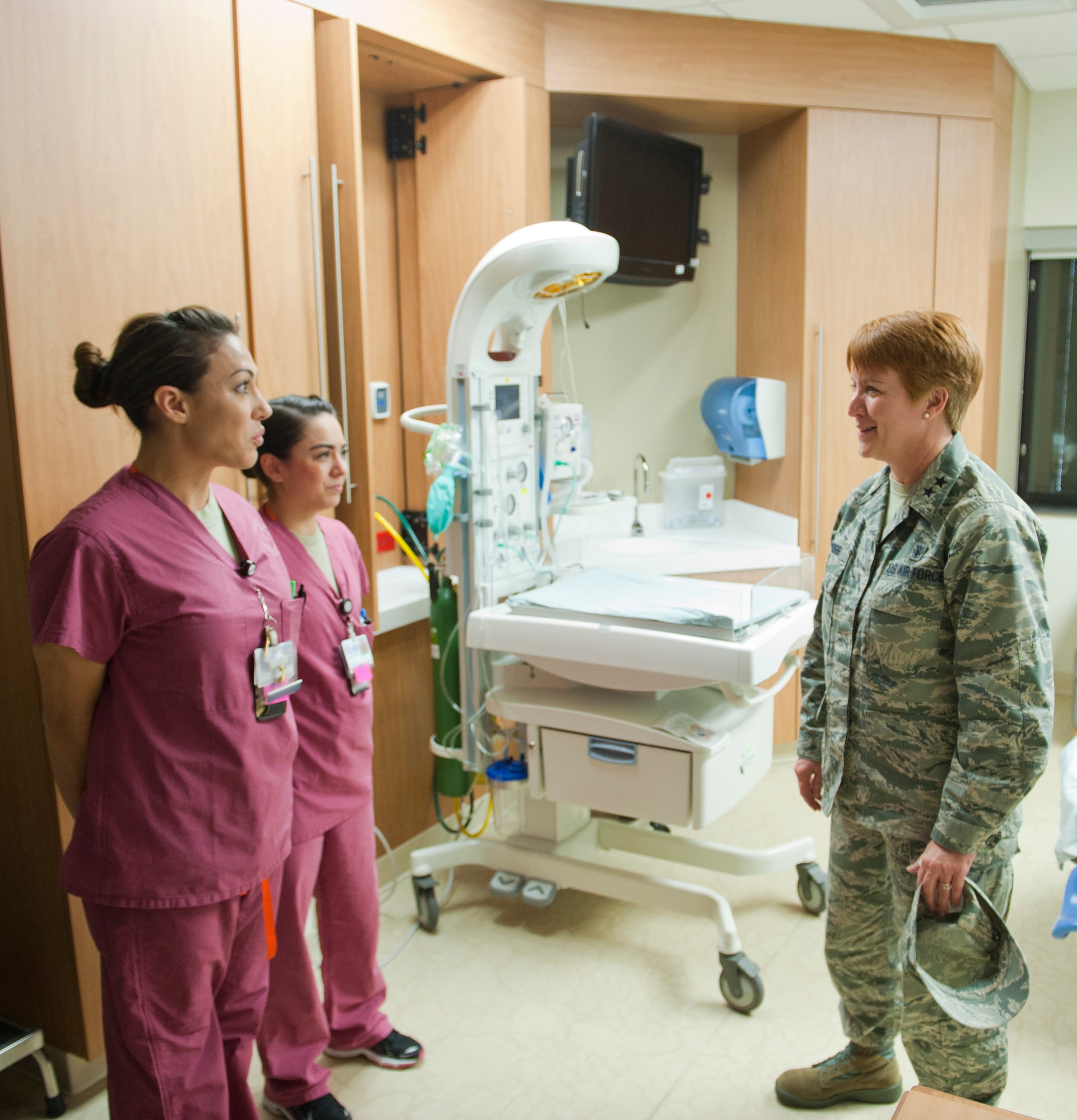 Second Lt. Theresa Jacobs-Bruner (left), 99th Inpatient Operations Squadron labor and delivery nurse, and Senior Airman Kayla Mills (center), 99th IPTS labor and delivery technician, brief Maj. Gen. Dorothy Hogg, U.S. Air Force director of medical operations and research and chief of the nurse corps, on the operations and capabilities of the labor and delivery ward at the Mike O’Callaghan Federal Medical Center, Nellis Air Force Base, Nev., Jan. 13, 2015. Hogg was visiting Nellis and the nearby University Medical Center of Southern Nevada to discuss the benefits of the Sustained Medical and Readiness Trained, or SMART, program. (U.S. Air Force photo illustration by Senior Airman Thomas Spangler) 