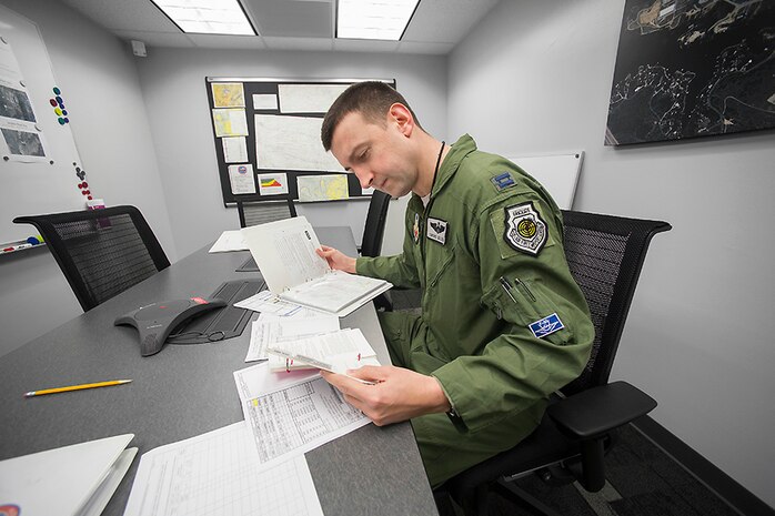 Capt. Brent Golden, 16th Weapons Squadron instructor, reviews his flight plan prior to departing the Lockheed Martin plant in the U.S. Air Force Weapons School’s first assigned F-35A Lightning II at Fort Worth, Texas, Jan. 15, 2015. While the first and subsequent USAFWS-assigned F-35s will initially operate under the umbrella of the 16th Weapons Squadron, the F-35 weapons school cadre will be built out of people from every mission design series. (Photo by Angel DelCueto, Lockheed Martin)