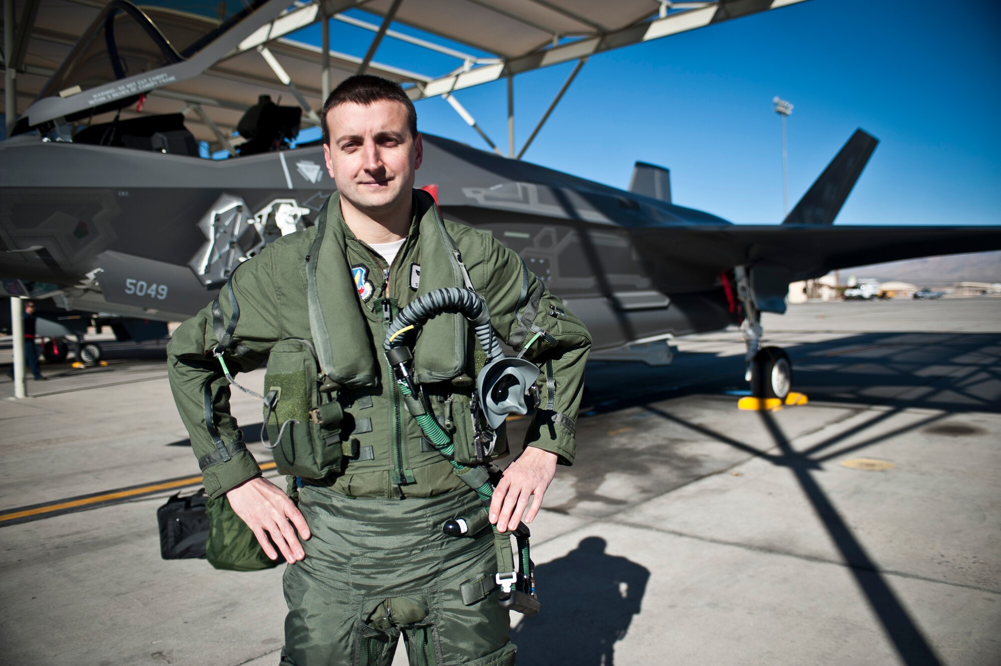 Capt. Brent Golden, 16th Weapons Squadron instructor, poses for a photo in front of the U.S. Air Force Weapons School’s first assigned F-35A Lightning II at Nellis Air Force Base, Nev., Jan. 15, 2015. Golden piloted the aircraft from Lockheed Martin’s plant in Fort Worth, Texas, to its new home at the USAFWS. (U.S. Air Force photo by Staff Sgt. Siuta B. Ika)