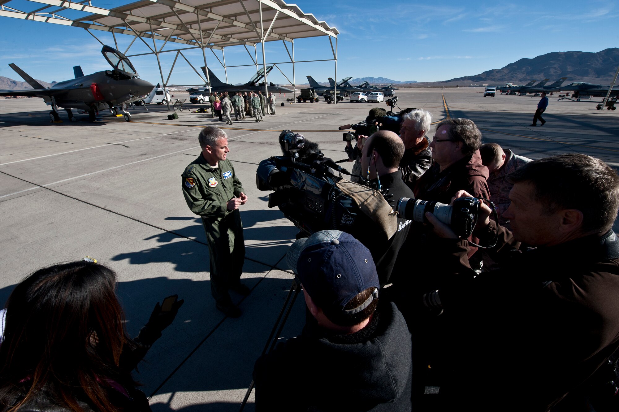 Maj. Gen. Jay Silveria, U.S. Air Force Warfare Center commander, answers questions from local media members after the arrival of the U.S. Air Force Weapons School’s first assigned F-35A Lightning II at Nellis Air Force Base, Nev., Jan. 15, 2015. The F-35 was flown directly from the Lockheed Martin plant in Fort Worth, Texas. (U.S. Air Force photo by Airman 1st Class Mikaley Towle)