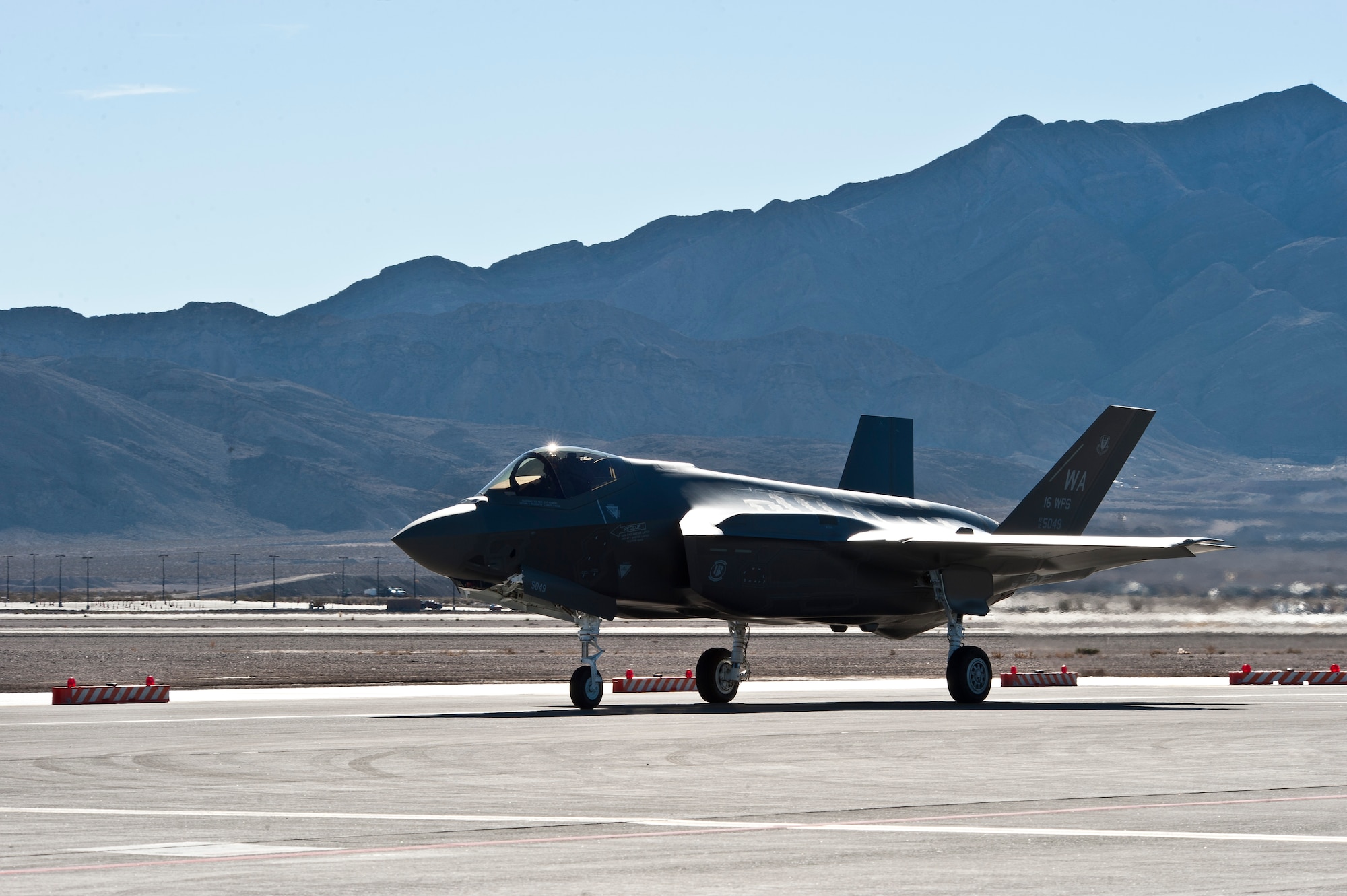 An F-35A Lightning II, piloted by Capt. Brent Golden, 16th Weapons Squadron instructor, taxis on the flightline at Nellis Air Force Base, Nev., Jan. 15, 2015. Golden flew the F-35 directly from the Lockheed Martin plant in Fort Worth, Texas, to its new home at the U.S. Air Force Weapons School. (U.S. Air Force photo by Airman 1st Class Mikaley Towle)