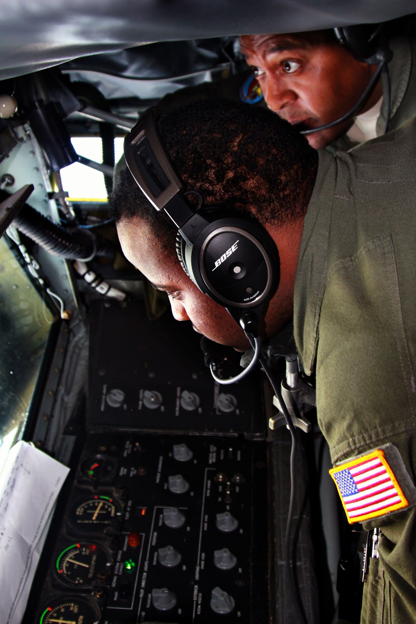 Airman 1st Class Andre McClain, a boom operator with the 171st Air Refueling Squadron, conducts an aerial refueling operation in a KC-135 Stratotanker while under the supervision of Master Sgt. George Hall, Jan. 13, 2014. McClain is a relatively recent addition to the 171st after initially joining the Michigan Air National Guard as a personnel specialist with the 127th Force Support Squadron. (U.S. Air National Guard photo by Tech. Sgt. Dan Heaton)