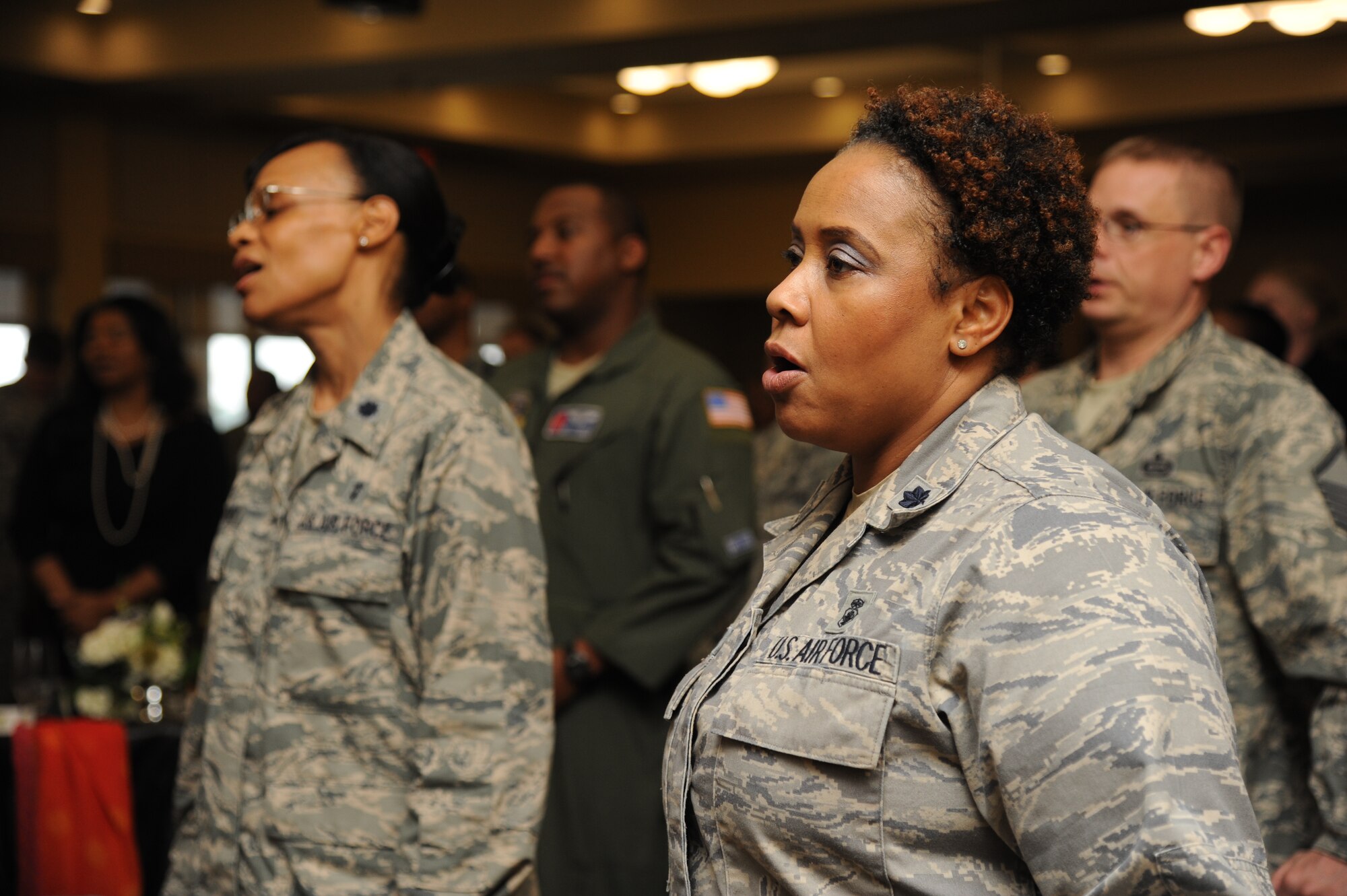 Lt. Cols. MiMi Cannonier, 81st Inpatient Operation Squadron commander, and Jacqueline Berry, 81st IPTS inpatient flight commander, sing “Lift Every Voice and Sing” at the annual Dr. Martin Luther King Jr. Memorial Luncheon Jan. 13, 2015, at the Bay Breeze Event Center, Keesler Air Force Base, Miss. The Keesler African-American Heritage Committee sponsored the event. (U.S. Air Force photo by Kemberly Groue)