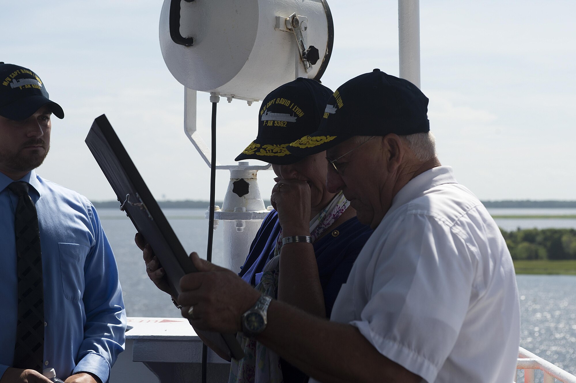 Capt. David I. Lyon's parents, Jeannie and Robert Lyon, look over a photograph given to them by the crew of the Motor Vessel Capt. David I. Lyon, Aug. 11, 2014, at Military Ocean Terminal Sunny Point in Southport, N.C. The MV Capt. David I. Lyon is an Air Force prepositioning vessel named in honor of Capt. David I. Lyon, an Air Force logistics readiness officer and 2008 U.S. Air Force Academy graduate who was killed in action Dec. 27, 2013, in Afghanistan. The vessel will transport critical war reserve materiel to locations around the globe. (U.S. Air Force photo/Tech. Sgt. Jason Robertson) 