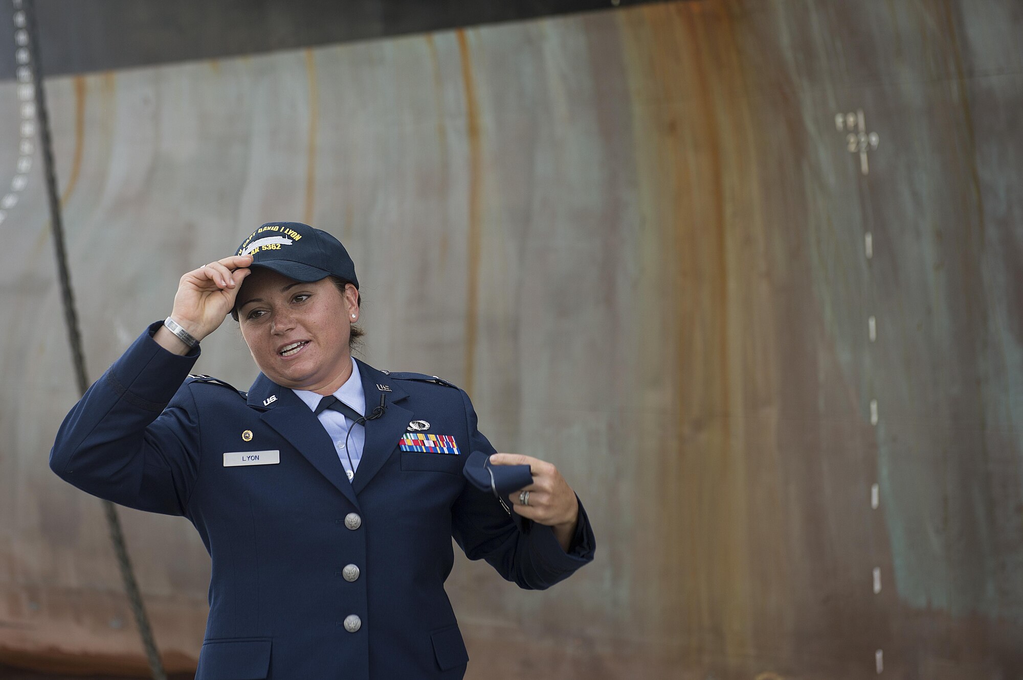 Capt. Dana M. Lyon, widow of Capt. David I. Lyon, dons a hat given to her by the crew of the Motor Vessel Capt. David I. Lyon during a christening and ship visit, Aug. 11, 2014, at Military Ocean Terminal Sunny Point in Southport, N.C. The MV Capt. David I. Lyon is an Air Force prepositioning vessel named in honor of Capt. David I. Lyon, an Air Force logistics readiness officer and 2008 U.S. Air Force Academy graduate who was killed in action Dec. 27, 2013, in Afghanistan. The vessel will transport critical war reserve materiel to locations around the globe. (U.S. Air Force photo/Tech. Sgt. Jason Robertson) 