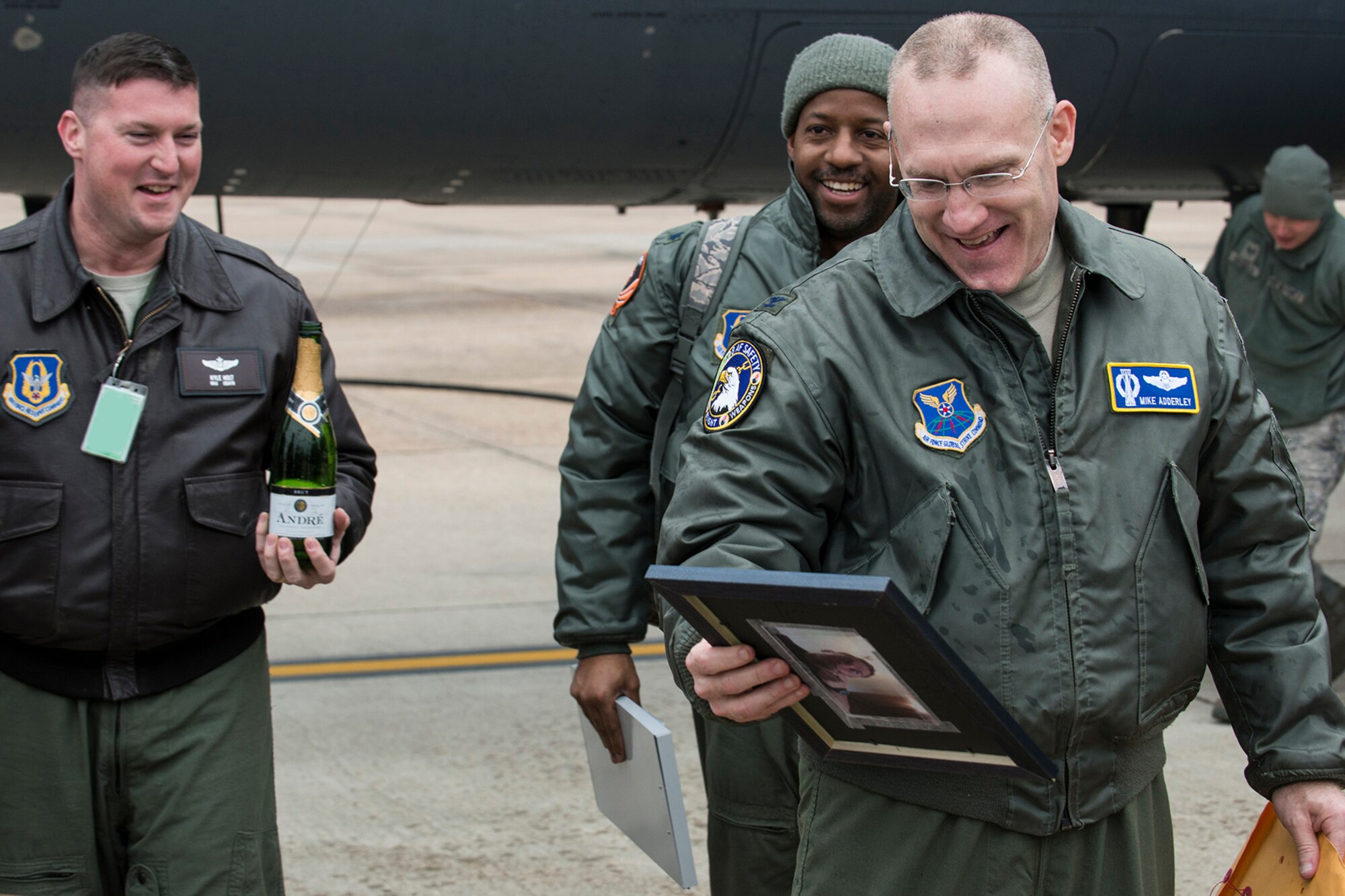 U.S. Air Force Col. Michael Adderley reacts to a gift given him by members of the 343rd Bomb Squadron (BS) after his return from a mission on Jan. 10, 2015, Barksdale Air Force Base, La. Adderley flew his last sortie in a B-52H Stratofortress with members of the 343rd BS before retiring after serving more than 20 years in the military. (U.S. Air Force photo by Master Sgt. Greg Steele/Released)