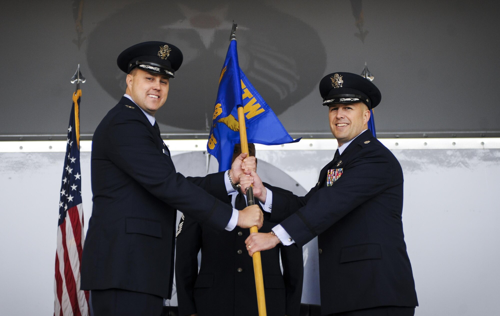 U.S. Air Force Lt. Col. Jeffrey Hogan (right), 81st Fighter Squadron commander, receives the guidon from Col. John Nichols, 14th Flying Training Wing commander, during an assumption of command ceremony Jan. 15, 2015, at Moody Air Force Base, Ga.  An assumption of command is a military tradition that represents a formal assumption of a unit’s authority and responsibility by a commander.  (U.S. Air Force photo by Senior Airman Sandra Marrero/Released)
