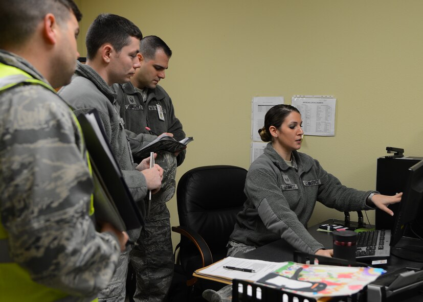 Staff Sgt. Lisa Hammett, 2nd Logistics Readiness Squadron NCO in-charge of individual protective equipment, explains the process of logging IPE during an Inspector General inspection on Barksdale Air Force Base, La., Jan. 12, 2015. Members of the 2nd Bomb Wing Inspection Team spoke with Airmen and their leadership to assess the organization from both an outside and inside persepective by talking with the individuals and listening to the feedback they provide. (U.S. Air Force photo/Senior Airman Joseph A. Pagán Jr.)