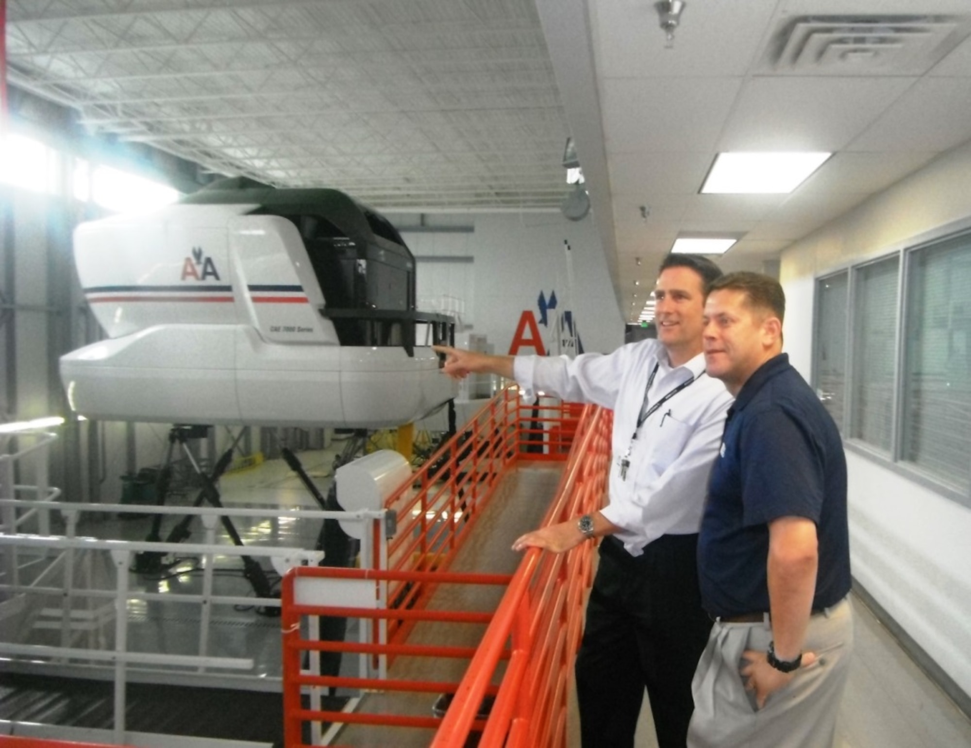 American Airlines Line Operations Safety Audit Manager, Captain Chris Moran, shows ANG Deputy Director of Safety, Mr. Dan Polanosky, safety features of American Airlines’ newest flight simulators. Courtesy Photo