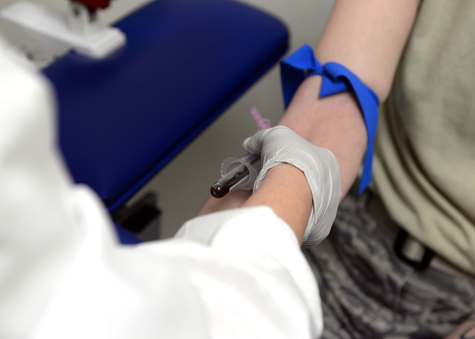 ALTUS AIR FORCE BASE, Okla. – U.S. Air Force Tech. Sgt. Kristi Jordan, 97th Medical Support Squadron NCO in charge of laboratory service, draws blood from a patient at the laboratory, Jan. 13, 2015. There are a variety of samples collected at the laboratory to determine whether an individual is healthy or not, such as blood, urine or sweat sample tests. (U.S. Air Force photo by Senior Airman Franklin R. Ramos/Released)