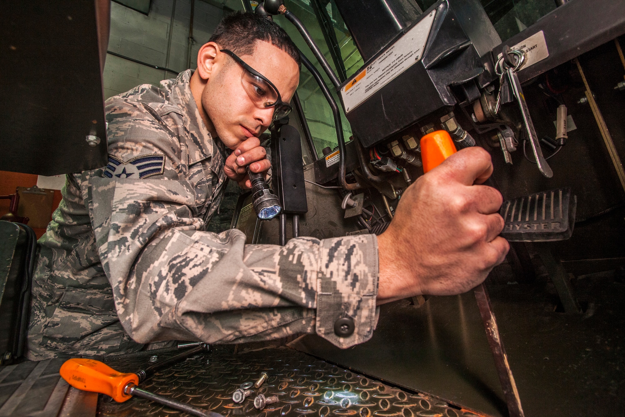 Senior Airman Christopher Garcia removes a panel to fix a neutral start switch on a 10K forklift at the 108th Wing Vehicle Maintenance Shop, New Jersey Air National Guard, at Joint Base McGuire-Dix-Lakehurst, N.J., Jan. 10, 2015. (U.S. Air National Guard photo by Master Sgt. Mark C. Olsen/Released)