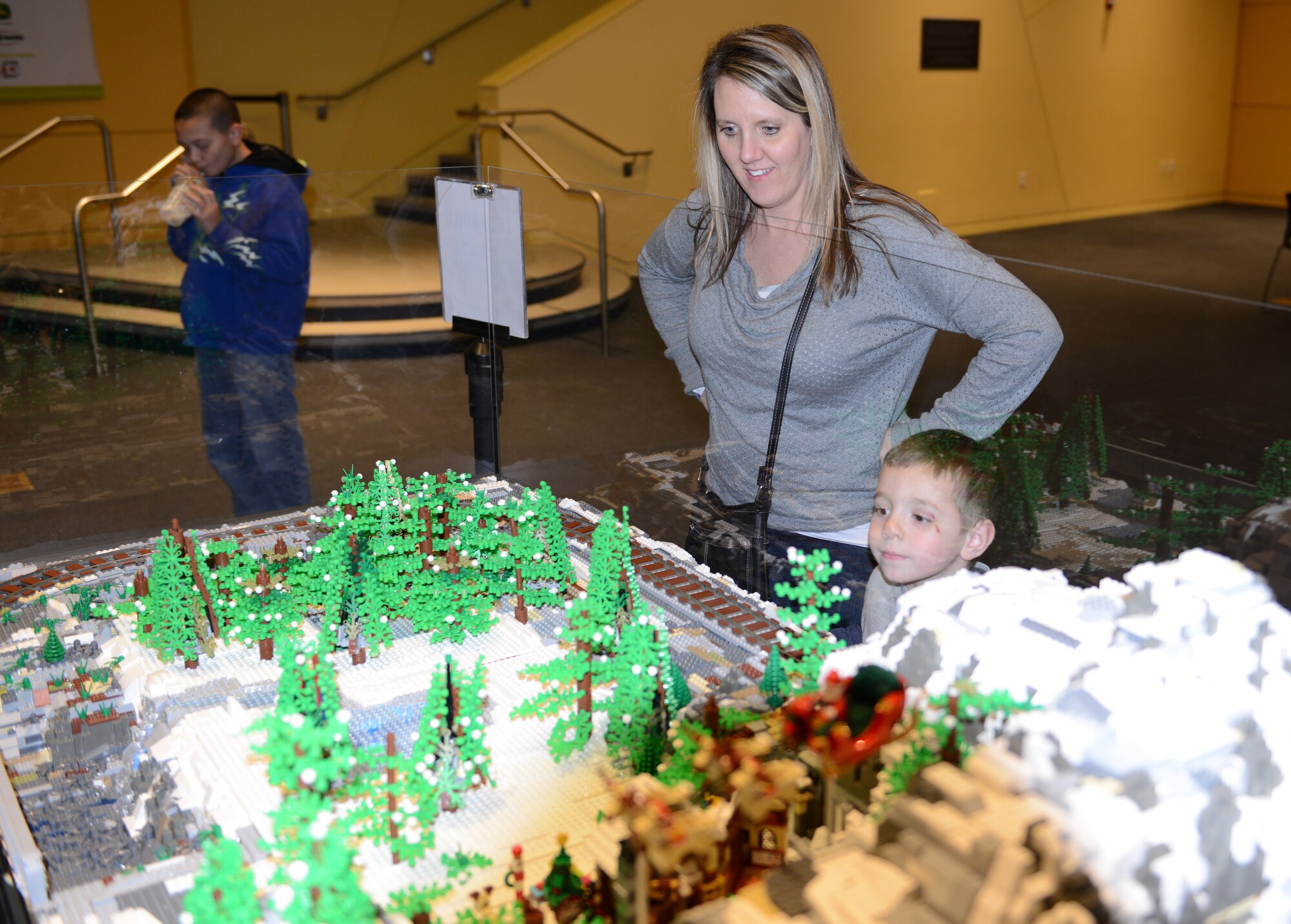 Science Center of Iowa on December 19, 2014, Military Family Connection Night sponsored by the Child and Youth Program of the Iowa National Guard. Master Sergeant Katherine Schultz showing her son the holiday Lego display.(U.S. Air National Guard photo by Technical Sgt. Michael McGhee/Released by Master Sgt. Robert P. Shepherd)