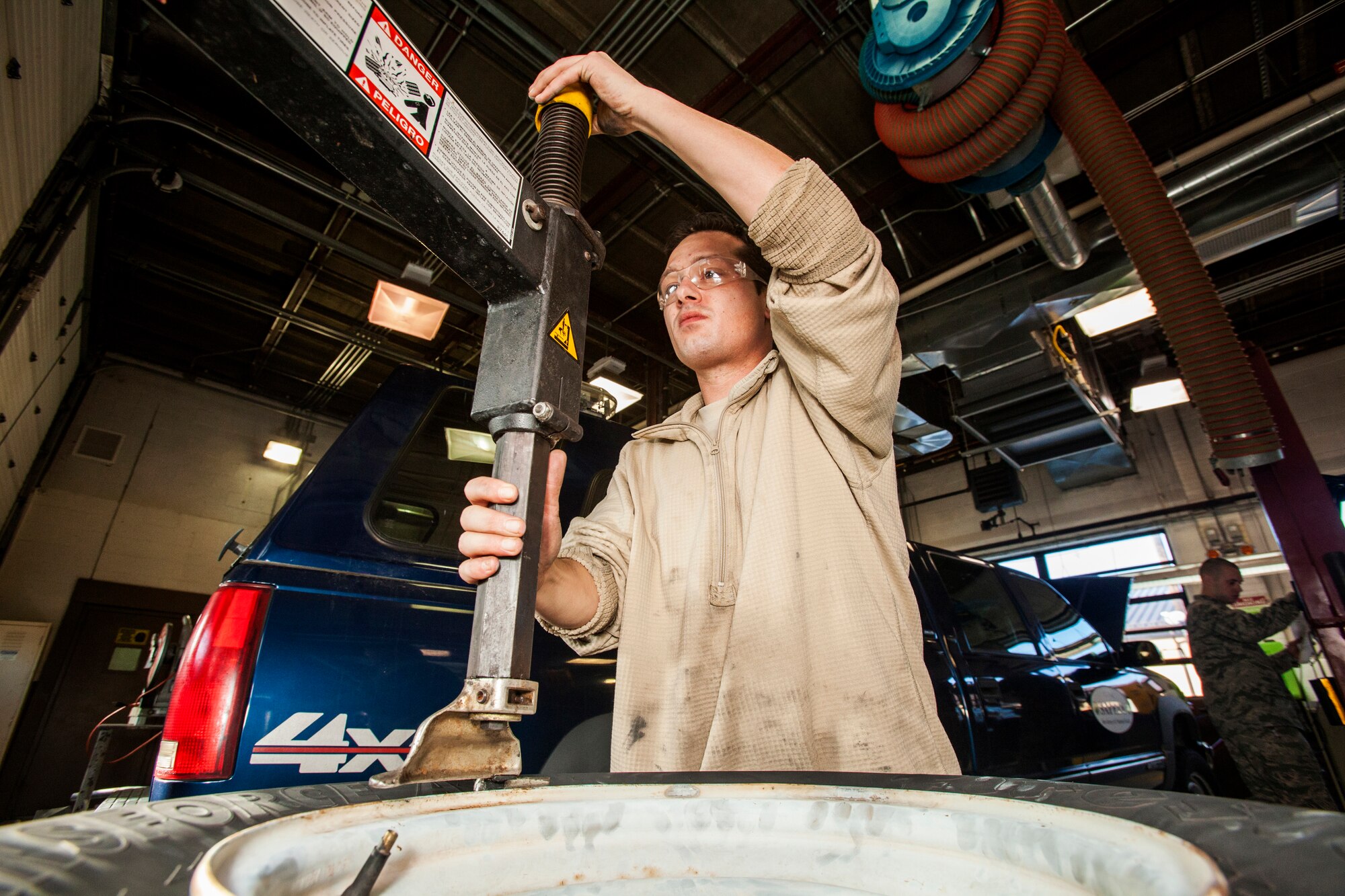 Senior Airman Robert Oakes prepares to take a tire off its rim at the 108th Wing Vehicle Maintenance Shop, New Jersey Air National Guard, Joint Base McGuire-Dix-Lakehurst, N.J., Jan. 10, 2015. (U.S. Air National Guard photo by Master Sgt. Mark C. Olsen/Released)