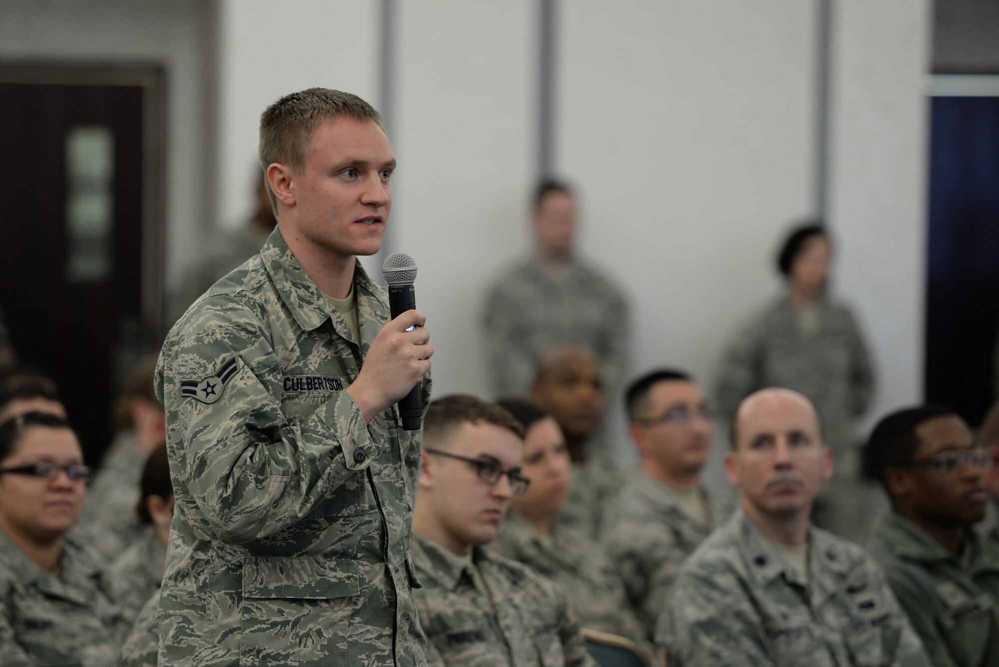 Airman 1st Class David Culbertson, 15th Operational Weather Squadron, asks a question during an all-call at Scott Air Force Base, Illinois, Jan. 12, 2015. Chief Master Sgt. of the Air Force James Cody spoke during the all-call about numerous topics and answered a number of questions from the crowd. (U.S. Air Force photo/Staff Sgt. Jonathan Fowler)