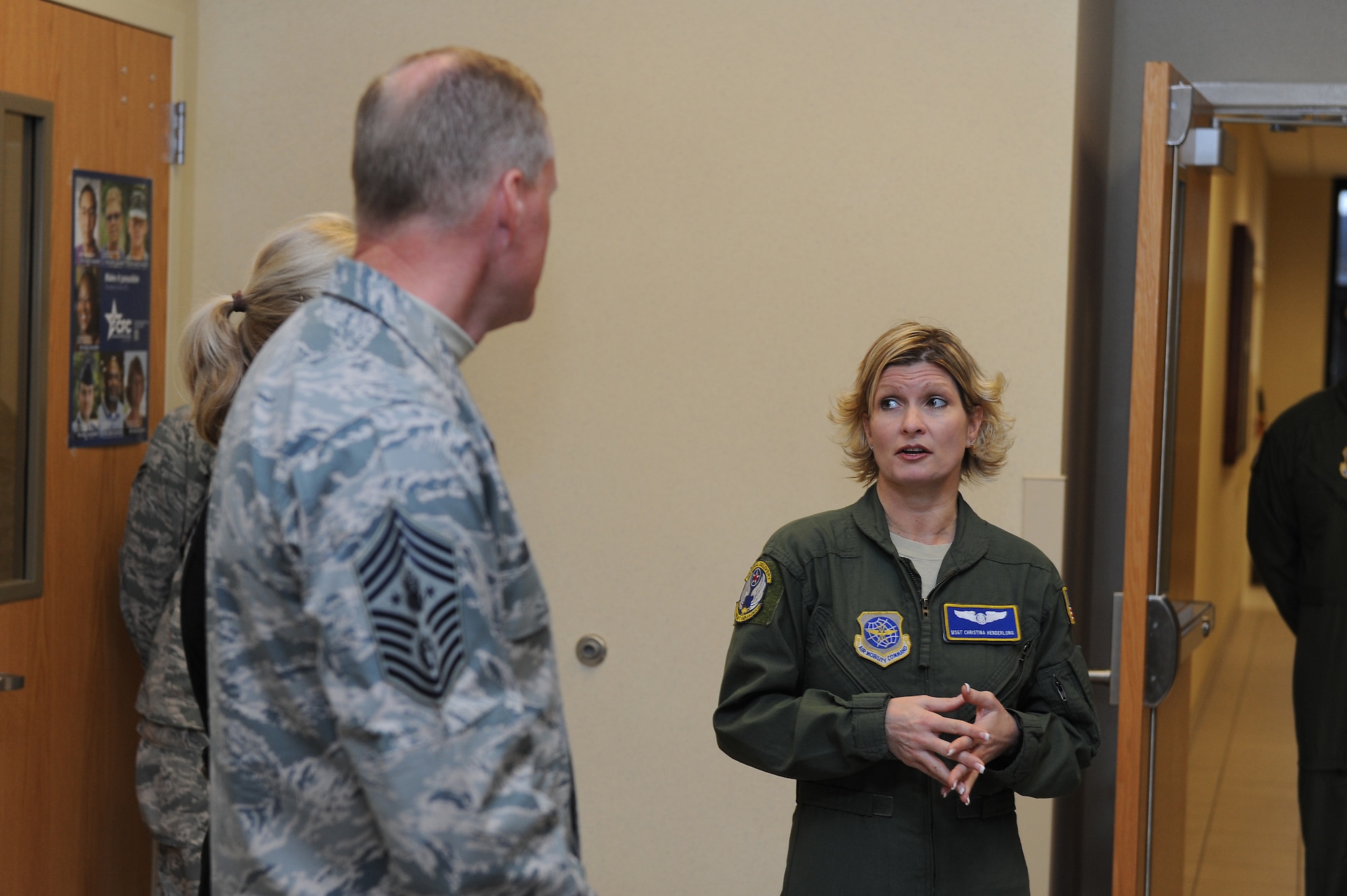 Chief Master Sgt. of the Air Force James Cody is briefed by Master Sgt. Christina Henderlong, 54th Airlift Squadron, during a tour at Scott Air Force Base, Illinois, Jan. 12, 2015. Henderlong emphasized the cooperation between guard, reserve and active duty members in the unit and how that benefits the individuals and the mission. (U.S. Air Force photo/Staff Sgt. Jonathan Fowler)
