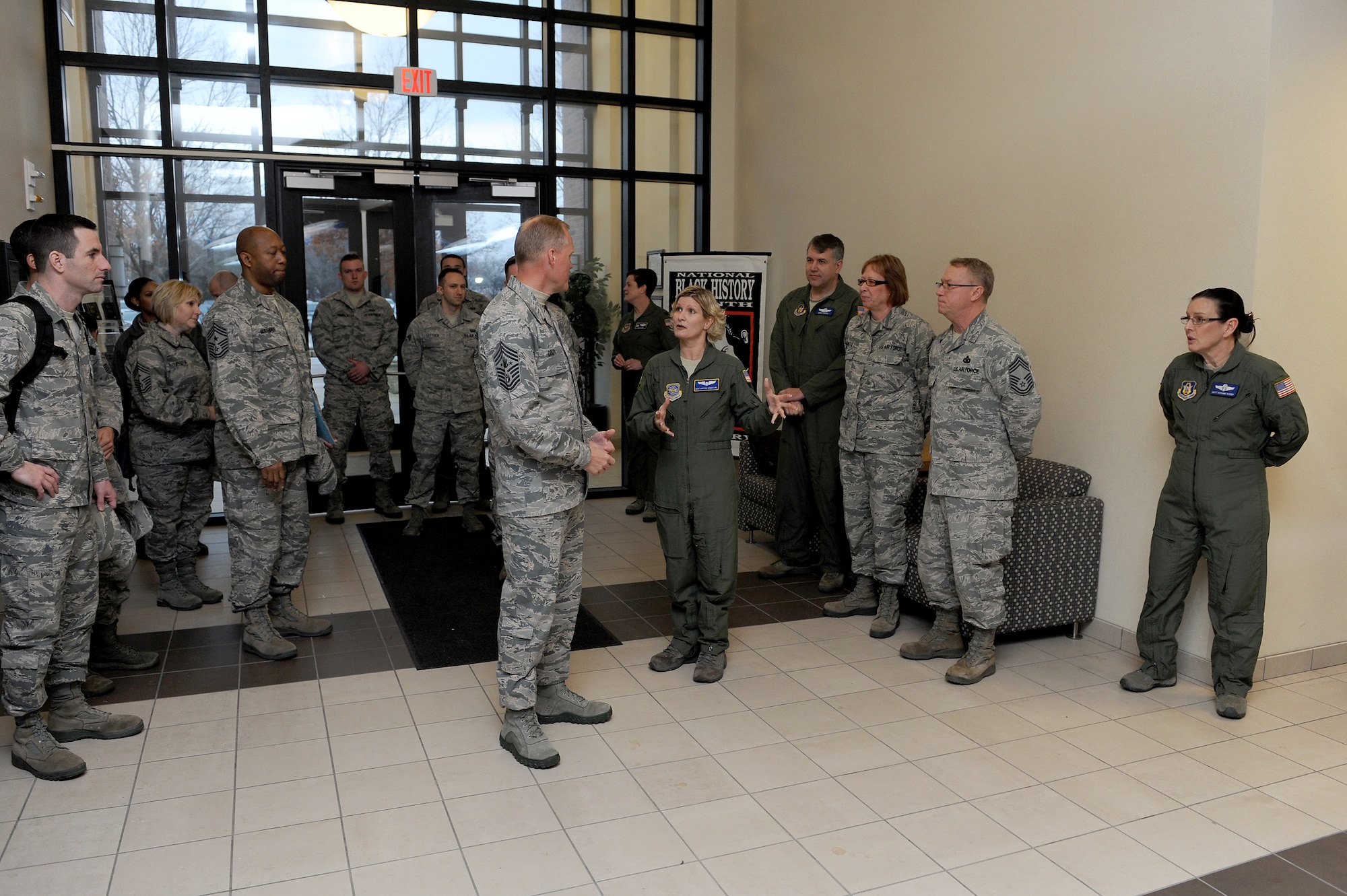 Chief Master Sgt. of the Air Force James Cody is briefed by Master Sgt. Christina Henderlong, 54th Airlift Squadron, during a tour at Scott Air Force Base, Illinois, Jan. 12, 2015. Henderlong emphasized the cooperation between guard, reserve and active duty members in the unit and how that benefits the individuals and the mission. (U.S. Air Force photo/Staff Sgt. Jonathan Fowler)