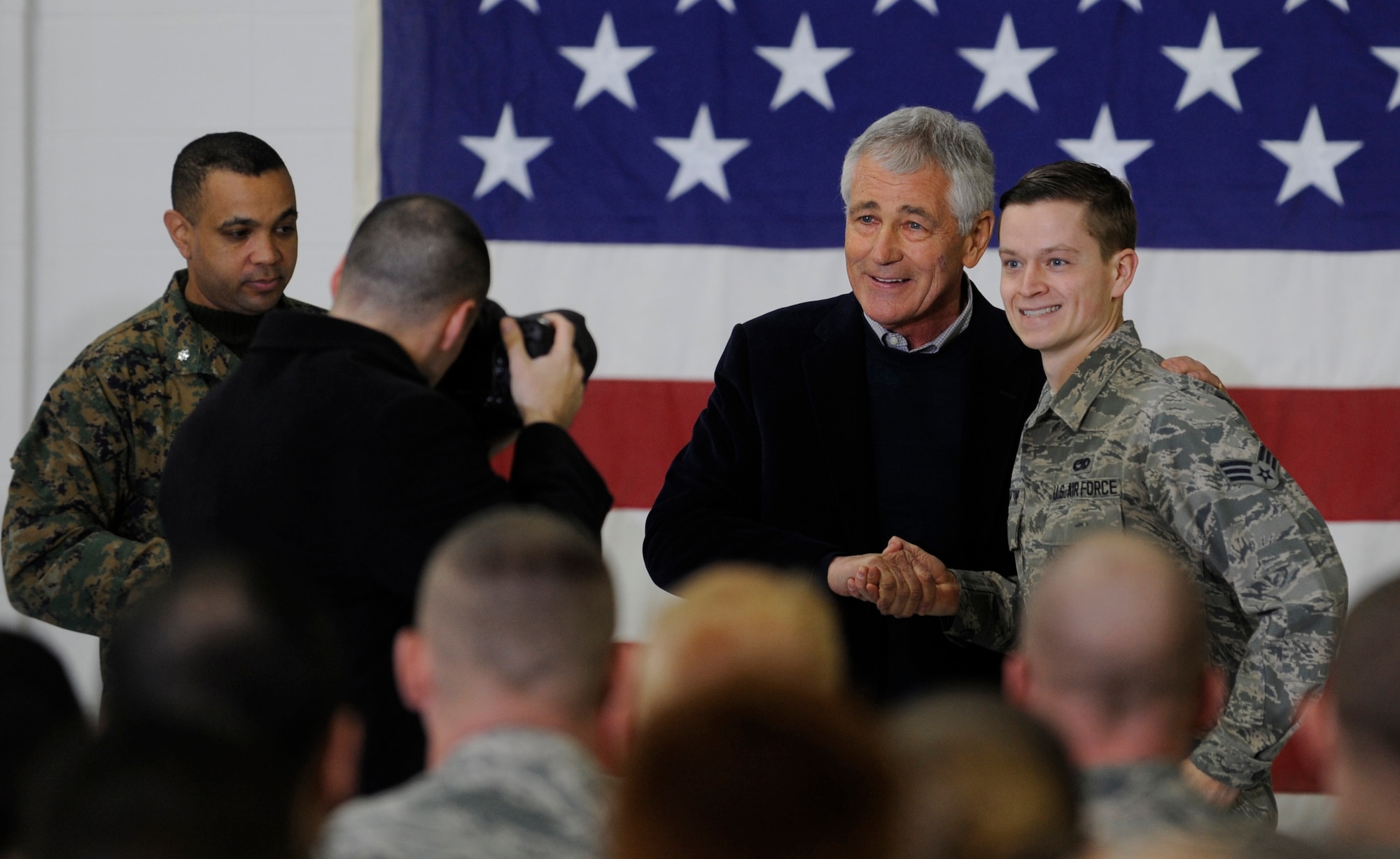 Defense Secretary Chuck Hagel coins an Airman who attended the Airmen’s Call during his farewell visit at Whiteman Air Force Base, Mo., Jan. 13, 2015. Hagel thanked the troops for their service and highlighted his support for the planned development of a new generation of long-range nuclear-capable bombers. (U.S. Air Force photo by Staff Sgt. Alexandra M. Boutte/Released)