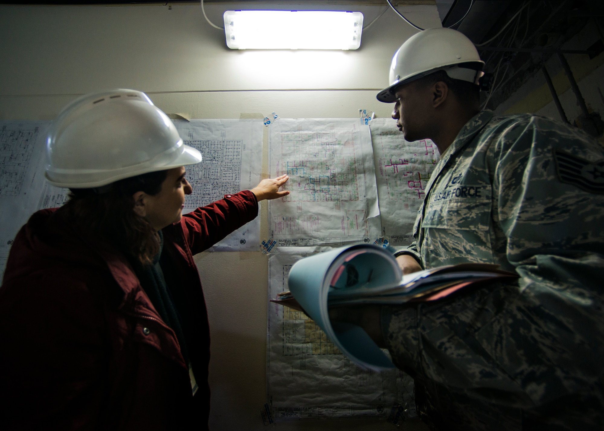 Tech. Sgt. Nicholas Northam, 39th Contracting Squadron NCO in charge of base infrastructure, reviews a blueprint during a site visit Jan. 8, 2015, at Incirlik Air Base, Turkey. The 39th CONS has strict principles and practices that must be followed before presenting any contract. (U.S. Air Force photo by Airman Cory W. Bush/Released)